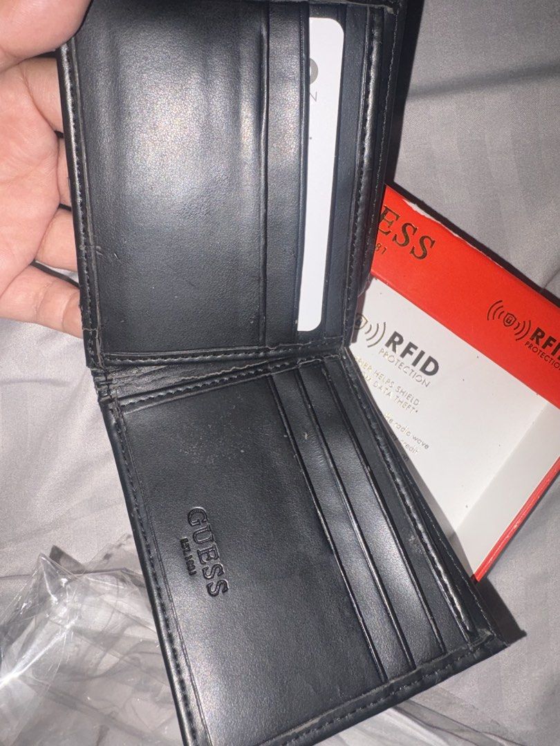 Guess RFID Protection Bifold Wallet Black (Category: Wallets & Card holders) located in Quezon. Submitted by shoppingmadness_ (Listing ID 1460658814, Image 2). Description: - Genuine Guess bifold wallet - Built-in RFID protection for security - Convenient zippered coin pocket on the exterior - Multiple card slots for organized storage - Includes original Guess box - Ideal for everyday carry -See pic for issues.