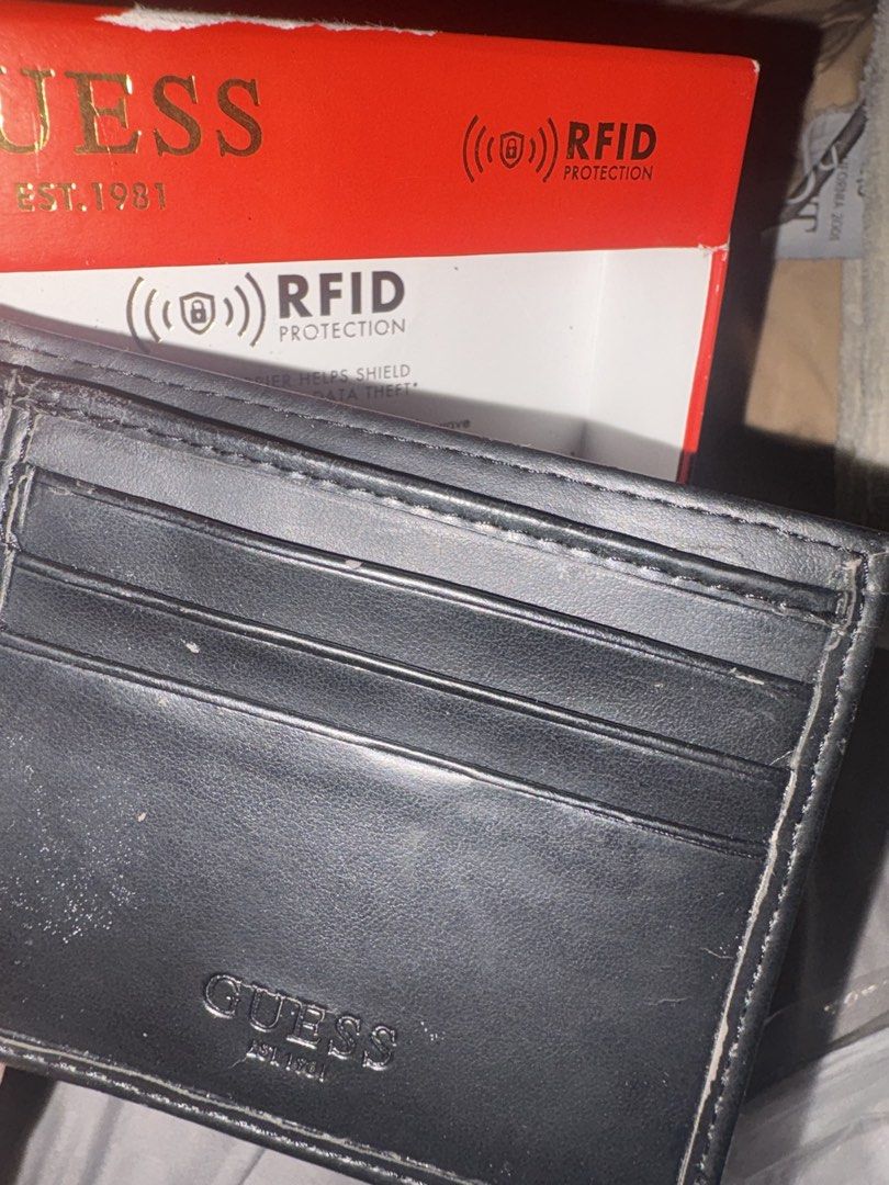 Guess RFID Protection Bifold Wallet Black (Category: Wallets & Card holders) located in Quezon. Submitted by shoppingmadness_ (Listing ID 1460658814, Image 3). Description: - Genuine Guess bifold wallet - Built-in RFID protection for security - Convenient zippered coin pocket on the exterior - Multiple card slots for organized storage - Includes original Guess box - Ideal for everyday carry -See pic for issues.