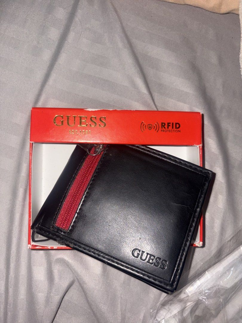 Guess RFID Protection Bifold Wallet Black (Category: Wallets & Card holders) located in Quezon. Submitted by shoppingmadness_ (Listing ID 1460658814, Image 1). Description: - Genuine Guess bifold wallet - Built-in RFID protection for security - Convenient zippered coin pocket on the exterior - Multiple card slots for organized storage - Includes original Guess box - Ideal for everyday carry -See pic for issues.