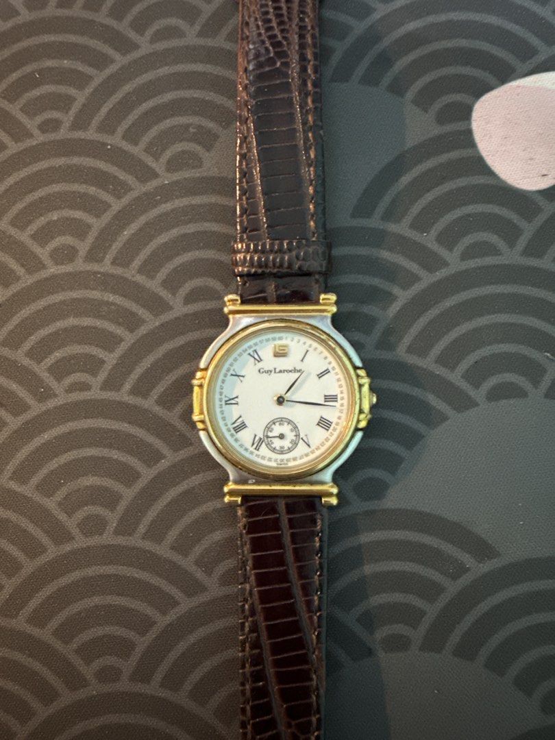 Guy Laroche Watch with Leather Strap (Category: Women's Watches) located in Quezon City. Submitted by shuks_9 (Listing ID 1460706170, Image 1). Description: - Classic Guy Laroche watch - White dial with Roman numerals - Small seconds subdial - Gold-tone bezel and accents - Brown leather strap -Battery not working - No Box.