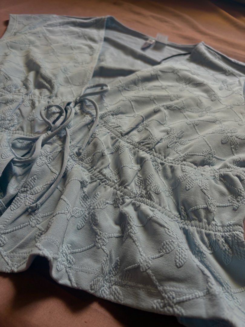 H&M Divided Light Blue Textured Tie Front Top (Category: Sleeveless) located in Marikina City. Submitted by momdeclutterz (Listing ID 1460653505, Image 3). Description: H&M Divided Size L Light blue Can pass as new Used once only during our Team Christmas Party Orig price: ₱799 RFS: Decluttering.