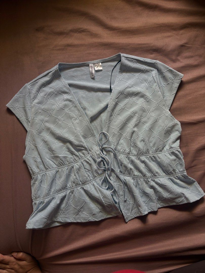 H&M Divided Light Blue Textured Tie Front Top (Category: Sleeveless) located in Marikina City. Submitted by momdeclutterz (Listing ID 1460653505, Image 1). Description: H&M Divided Size L Light blue Can pass as new Used once only during our Team Christmas Party Orig price: ₱799 RFS: Decluttering.