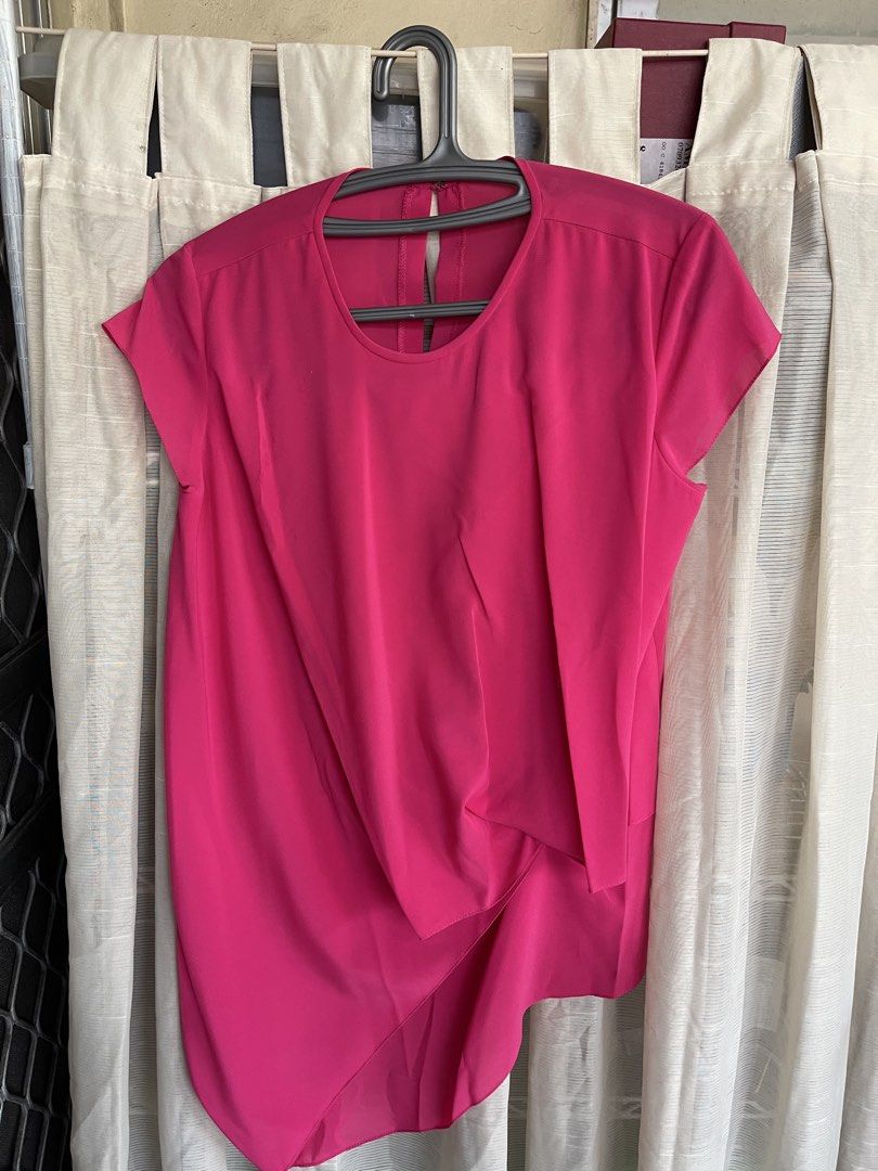 Hot Pink Asymmetrical Drape Top (Category: Sleeveless) located in Mandaluyong City. Submitted by coolmeybab (Listing ID 1460534299, Image 1). Description: - Bright hot pink short-sleeve top - Unique asymmetrical drape detail on the front - Keyhole closure at the back with a button - Lightweight and flowy material - Versatile: dress up or down, pairs well with jeans or skirts.