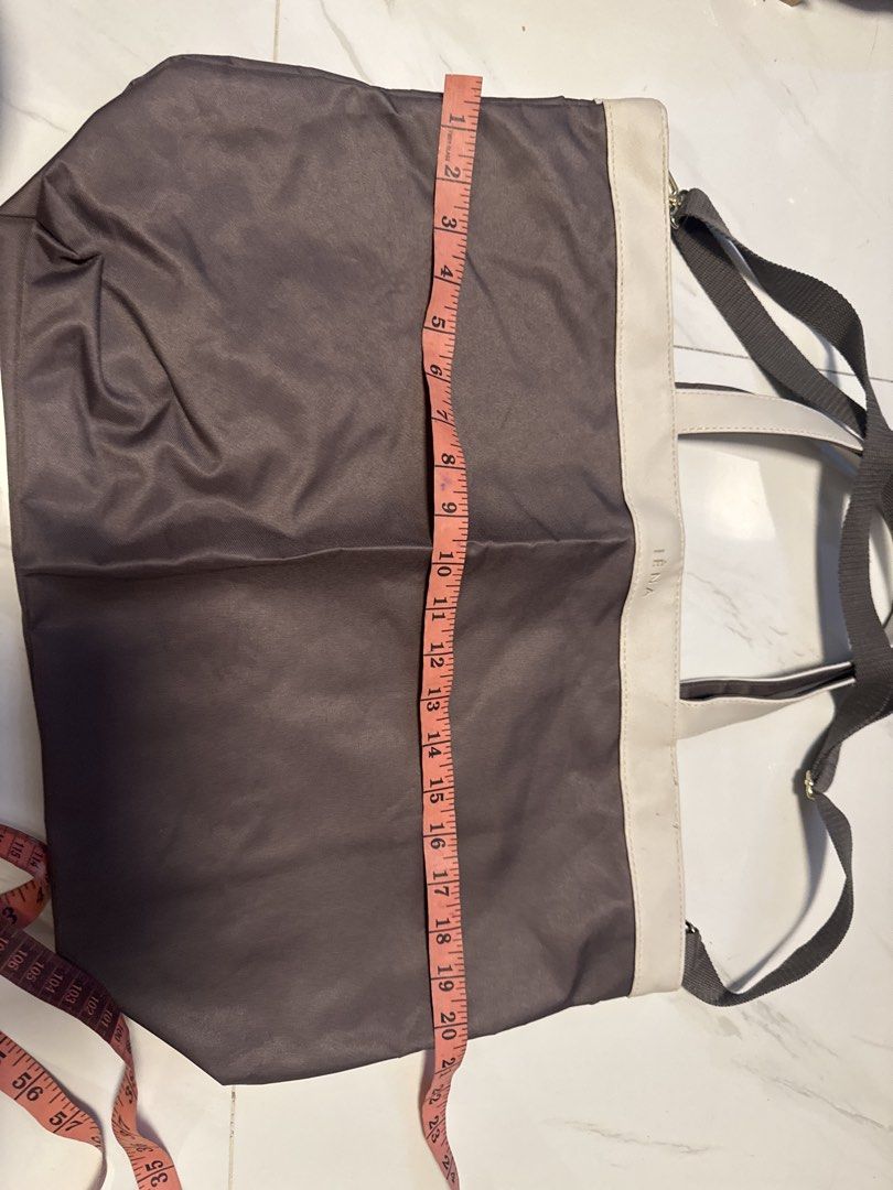 IENA Tote Bag (Category: Tote Bags) located in Silang. Submitted by sari2bilina (Listing ID 1460667154, Image 3). Description: - Stylish grey tote bag with elegant cream trim. - Features the embossed 'IENA' brand name on the trim. - Comes with two comfortable top handles. - Includes a long, adjustable strap for versatile carrying options. - Generously sized for all your essentials: approx. 38cm Height x 45cm Width..