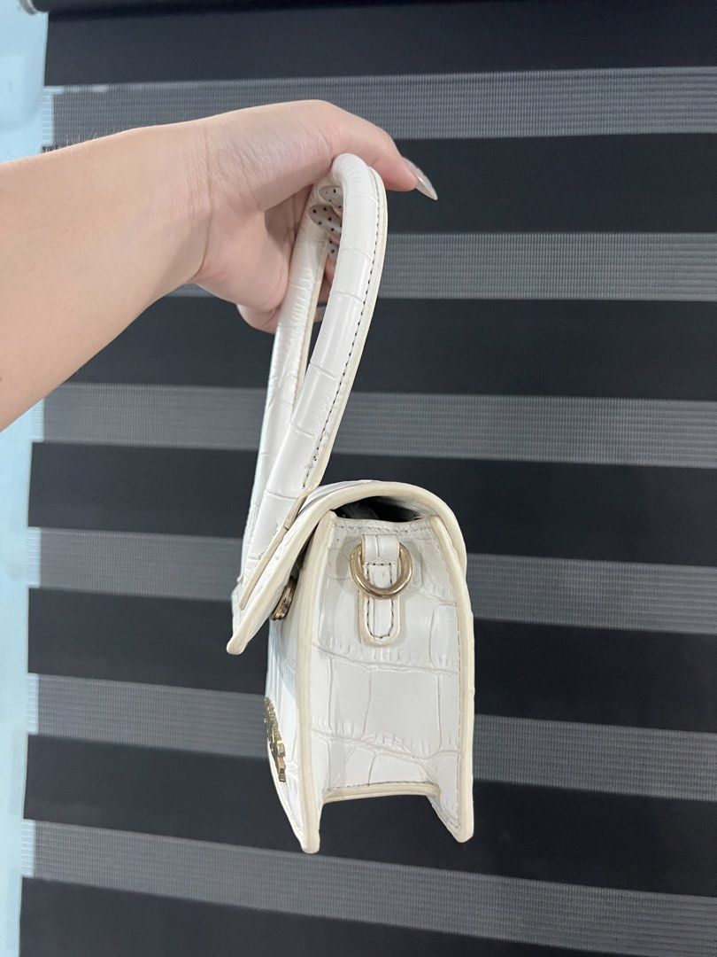 Jacquemus White Croc Embossed Mini Bag (Category: Luxury Bags & Wallets) located in Manila. Submitted by camieday04 (Listing ID 1460688994, Image 3). Description: - Adorable white mini bag(NGA) - Features croc embossed texture - Accented with a gold Jacquemus logo - Versatile wear: top handle or long strap - Ideal for nights out or elevating any look - Compact and stylish.