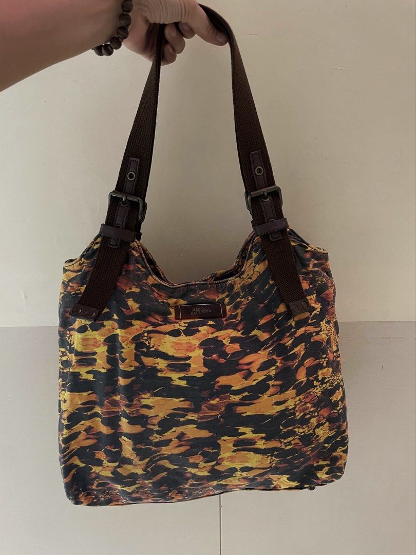 Jean Paul Gaultier Shoulder Bag (Category: Luxury Bags & Wallets) located in Manila. Submitted by thevintagebow (Listing ID 1460711815, Image 1). Description: Chic, rare, and unapologetically iconic. ✨ Elevate your rotation with this vintage Jean Paul Gaultier shoulder bag, featuring a striking abstract fiery print against a dark backdrop. Designed with rich brown webbing straps, adjustable buckle details, and a spacious interior complete with or