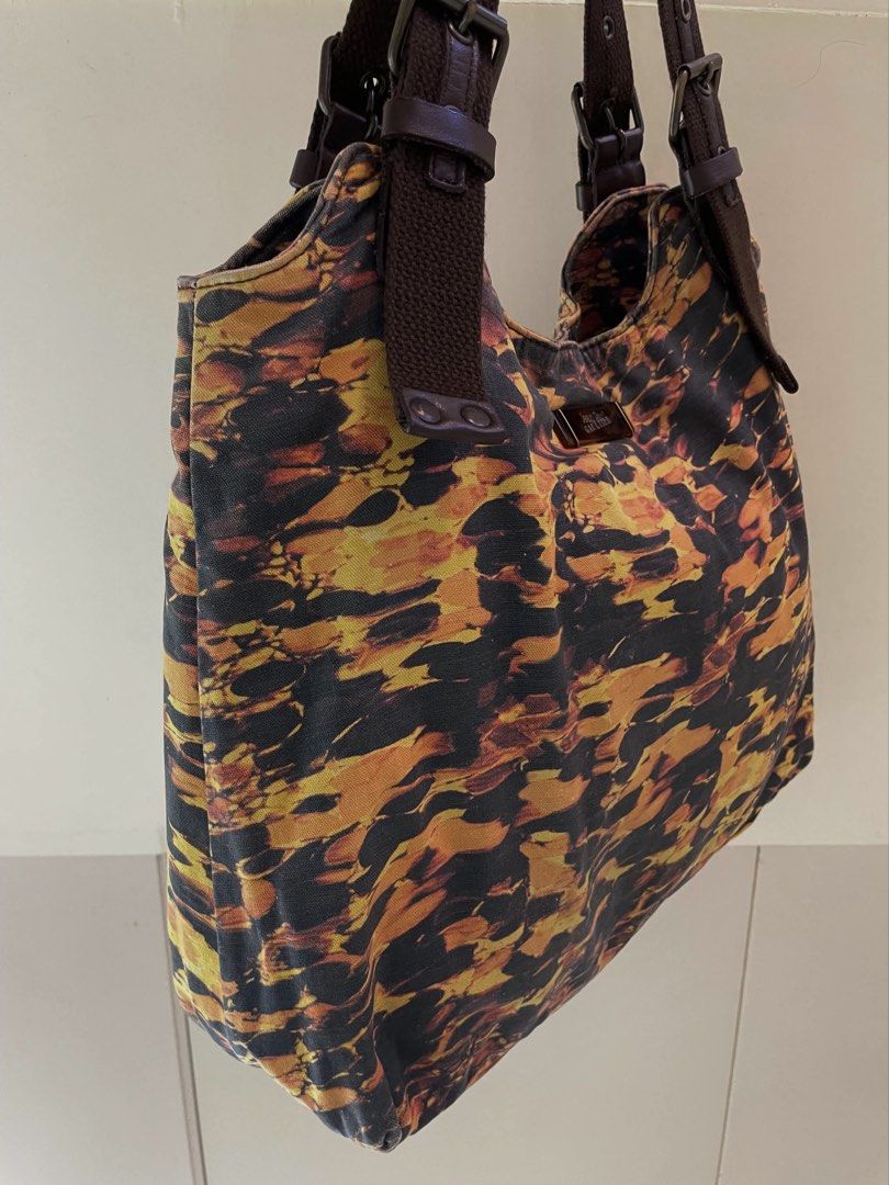Jean Paul Gaultier Shoulder Bag (Category: Luxury Bags & Wallets) located in Manila. Submitted by thevintagebow (Listing ID 1460711815, Image 2). Description: Chic, rare, and unapologetically iconic. ✨ Elevate your rotation with this vintage Jean Paul Gaultier shoulder bag, featuring a striking abstract fiery print against a dark backdrop. Designed with rich brown webbing straps, adjustable buckle details, and a spacious interior complete with or