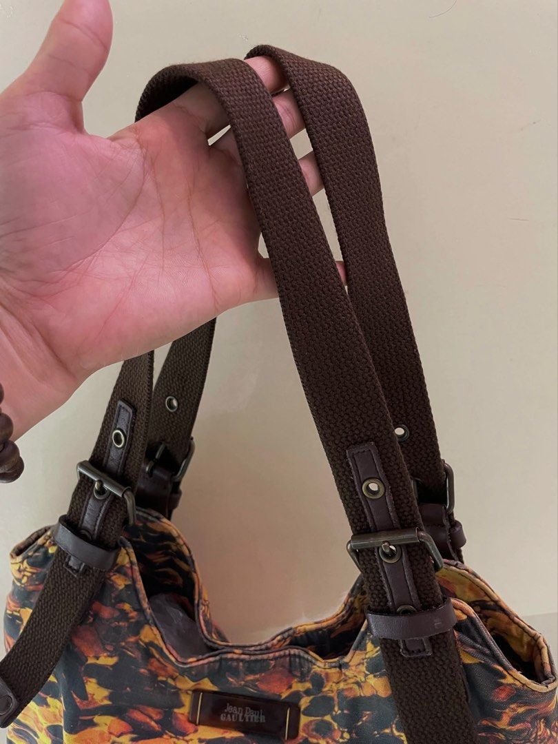 Jean Paul Gaultier Shoulder Bag (Category: Luxury Bags & Wallets) located in Manila. Submitted by thevintagebow (Listing ID 1460711815, Image 3). Description: Chic, rare, and unapologetically iconic. ✨ Elevate your rotation with this vintage Jean Paul Gaultier shoulder bag, featuring a striking abstract fiery print against a dark backdrop. Designed with rich brown webbing straps, adjustable buckle details, and a spacious interior complete with or