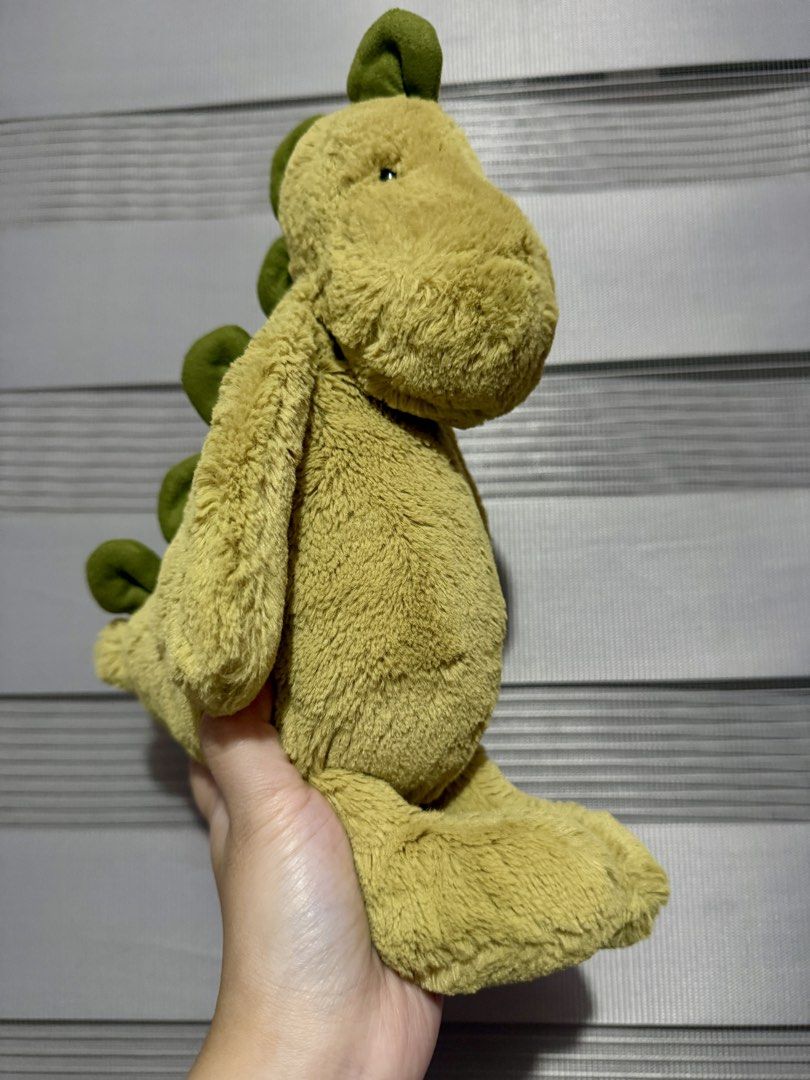 Jellycat Bashful Dino Medium (Category: Plushies & Soft Toys) located in Manila. Submitted by bcbg3217 (Listing ID 1460700520, Image 1). Description: ‼️PLEASE READ BEFORE BUYING‼️ Like new condition Medium size Super soft fur Authenticity NOT guaranteed (Please do your own checking too) No other jellycat inclusions Actual photos are posted No other issues or flaws unless stated Please check the photos thoroughly before placing an order JnT regula