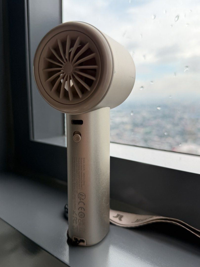 Jisulife Handheld Portable Fan – Beige (Category: Fans) located in Taytay. Submitted by thestyletwins (Listing ID 1460664964, Image 2). Description: Selling preloved Jisulife handheld portable fan. * Compact and portable * Adjustable fan speed * Digital display * Rechargeable * Wrist strap included * Beige color Condition: Preloved, working properly. Has normal signs of use. Please see photos for actual condition. RFS: Decluttering..