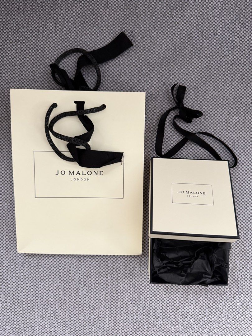 Jo Malone London Gift Bag and Box (Category: Luxury Bags & Wallets) located in Manila. Submitted by hotdealsph (Listing ID 1460572199, Image 1). Description: - Authentic Jo Malone London gift bag and matching gift box - Elegant cream color with classic black ribbon handles and accents - Box includes black tissue paper, ready for gifting - Ideal for presenting gifts or storing small precious items.