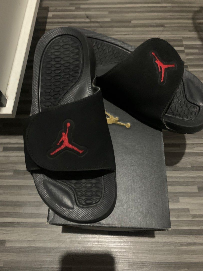 Jordan Slides Black Red (Category: Slippers & Slides) located in Manila. Submitted by khianyanique (Listing ID 1460710347, Image 1). Description: - Black Jordan V retro - Iconic red Jumpman logo - Comfortable footbed with textured grip - Ideal for casual wear or after sports - Comes with original box.