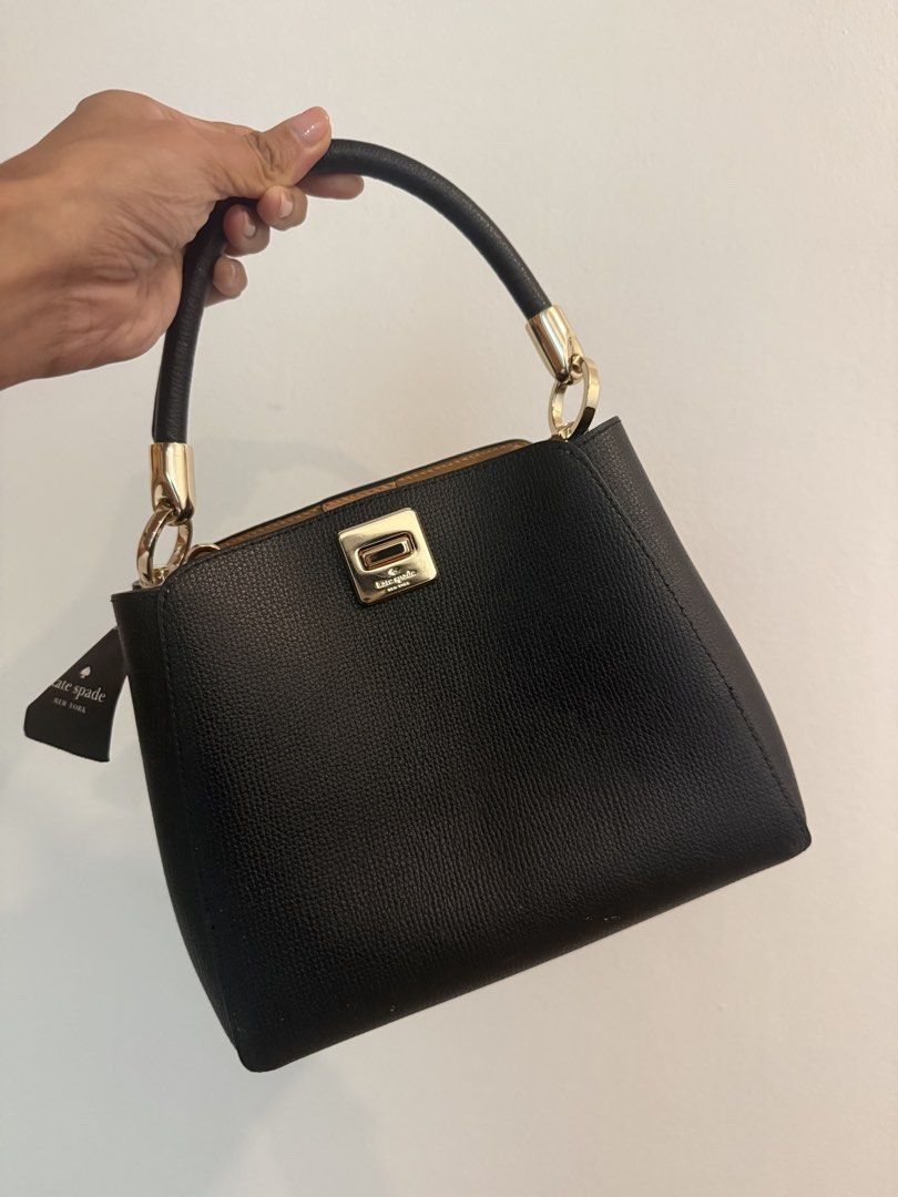 Kate Spade Black Leather Top Handle Bag (Category: Shoulder Bags) located in Quezon City. Submitted by sabinalopez821 (Listing ID 1460508582, Image 1). Description: - Genuine black pebbled leather Kate Spade bag - Elegant gold hardware details - Versatile top handle and detachable strap - Iconic Kate Spade logo on front clasp - Includes original tag - Ideal for both daily wear and special events.