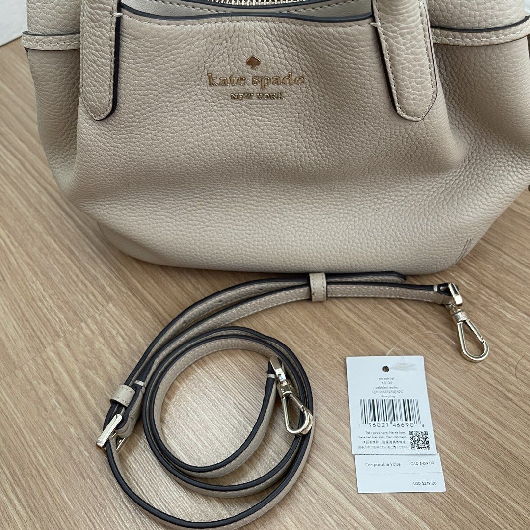 Kate Spade SMALL Dumpling Light Sand; Pebble Leather Bag (Category: Luxury Bags & Wallets) located in Makati City. Submitted by marie.tan (Listing ID 1460567991, Image 2). Description: - Light beige Kate Spade satchel bag - Crafted from durable pebble leather - Versatile with top handles and a detachable crossbody strap - Interior zip pocket for secure storage - Elegant gold hardware - Comes with original tag.