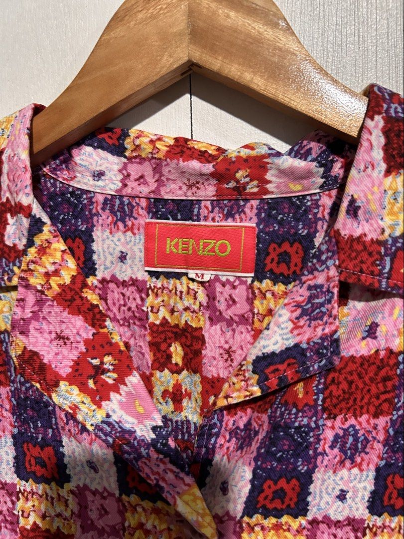 KENZO Multicolor Geometric Print Button-Up Shirt Size M (Category: Tshirts & Polo Shirts ) located in Tuguegarao City. Submitted by thrift_ni_boy (Listing ID 1460537002, Image 2). Description: - Kenzo Shirt - Size: M - Design: Vibrant geometric and floral print - Features: Collared neckline, button-up front, three-quarter sleeves - Origin: Made in Japan - Style Tip: Perfect for adding a pop of color to your outfit.