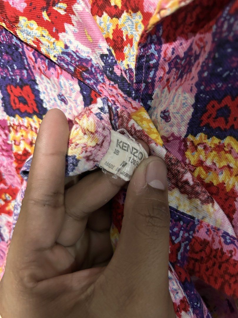 KENZO Multicolor Geometric Print Button-Up Shirt Size M (Category: Tshirts & Polo Shirts ) located in Tuguegarao City. Submitted by thrift_ni_boy (Listing ID 1460537002, Image 3). Description: - Kenzo Shirt - Size: M - Design: Vibrant geometric and floral print - Features: Collared neckline, button-up front, three-quarter sleeves - Origin: Made in Japan - Style Tip: Perfect for adding a pop of color to your outfit.