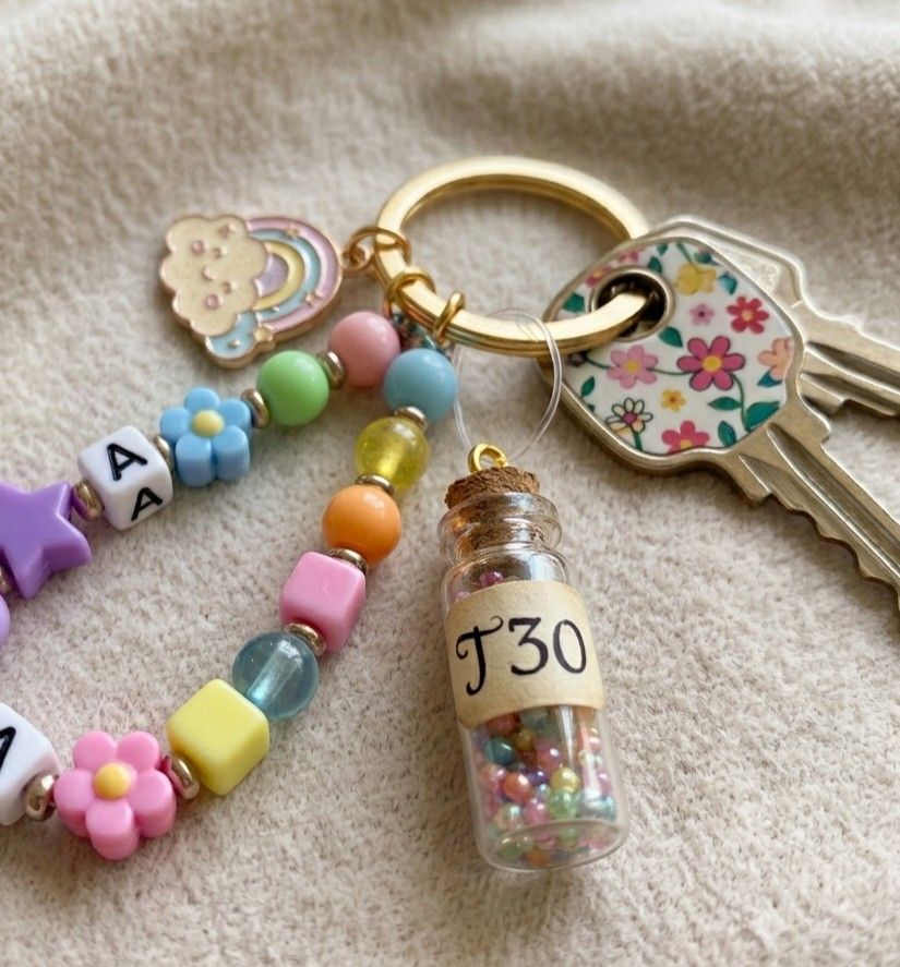 KeyChain TirTir30mg. (Category: Charms) located in Manila. Submitted by biohack777 (Listing ID 1460509023, Image 1). Description: - Adorable handmade keychain - Features colorful beads and letter charms - Includes a cute rainbow cloud charm - Tiny bottle filled with beads, labeled 'J30' - Versatile as a keychain or bag charm - Unique and fun accessory.