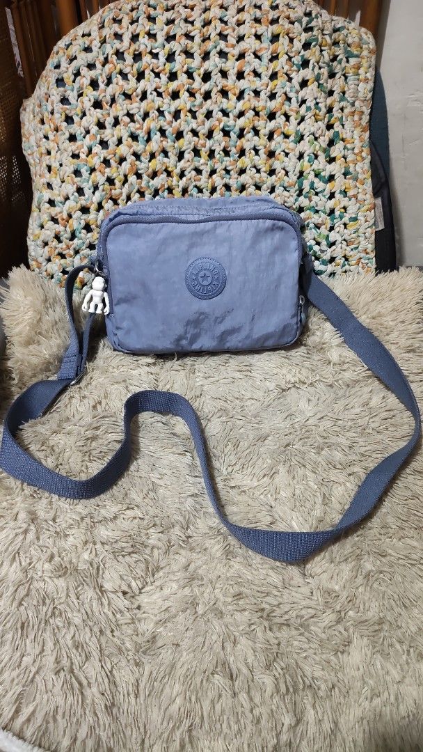 Kipling Blue Nylon Crossbody Bag with Monkey Charm (Category: Cross-body Bags) located in Cebu City. Submitted by lumaynojes00490 (Listing ID 1460535165, Image 1). Description: - Blue Kipling crossbody bag - Durable nylon material - Secure zipper closure - Adjustable strap for comfort - Comes with the iconic Kipling monkey charm - Ideal for everyday use and travel - Spacious interior for your essentials.