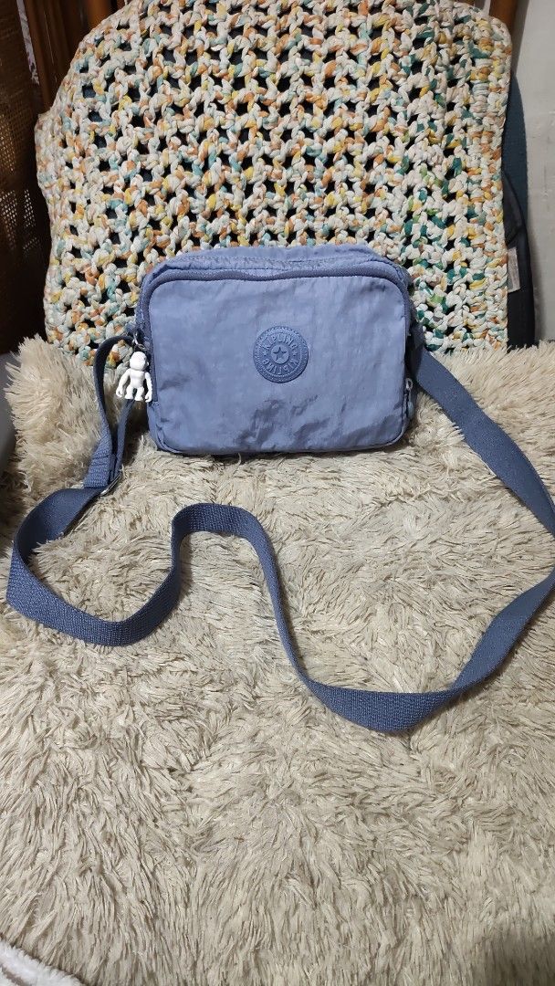 Kipling Blue Nylon Crossbody Bag with Monkey Charm (Category: Cross-body Bags) located in Cebu City. Submitted by lumaynojes00490 (Listing ID 1460535165, Image 2). Description: - Blue Kipling crossbody bag - Durable nylon material - Secure zipper closure - Adjustable strap for comfort - Comes with the iconic Kipling monkey charm - Ideal for everyday use and travel - Spacious interior for your essentials.