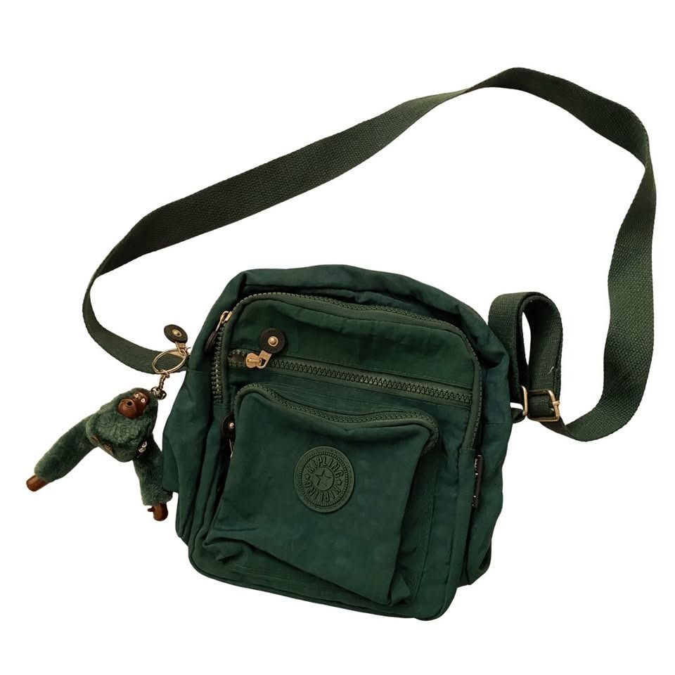 Kipling Green Nylon Crossbody Bag with Monkey Charm (Category: Cross-body Bags) located in Quezon City. Submitted by SustainableFashionatbp (Listing ID 1460541586, Image 1). Description: - Green Kipling crossbody bag - Made of durable nylon - Features multiple zippered compartments for organization - Includes the iconic Kipling monkey charm - Adjustable shoulder strap for comfortable wear - Ideal for everyday use or travel.