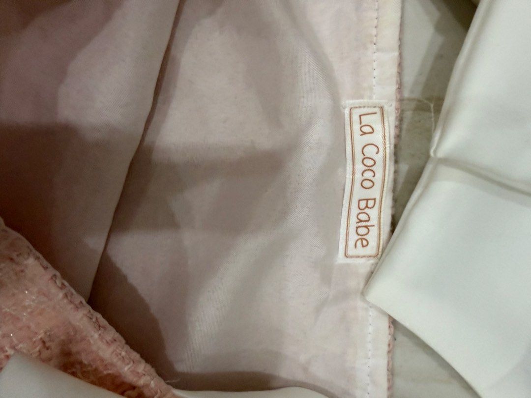 La Coco Babe Pink Tweed Top with White [Last Price Posted] (Category: Sleeveless) located in Pasig City. Submitted by luxurypreloved12 (Listing ID 1460576260, Image 3). Description: - Pink tweed top from La Coco Babe - Features cute white bows on the shoulders - Square neckline - Pairs well with jeans or skirts - Perfect for a chic, feminine, and stylish look - Comfortable for any occasion - Minor Stains as seen in pics above No LP lowballers or 