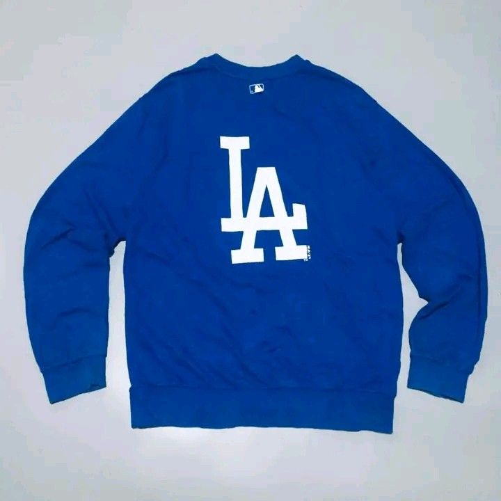 LA Dodgers MLB Blue Crewneck Sweatshirt (Category: Coats, Jackets and Outerwear) located in Calbayog City. Submitted by taking-candy.ph (Listing ID 1460656576, Image 1). Description: - Official MLB merchandise - Blue crewneck sweatshirt - Iconic LA Dodgers 'LA' logo on front and back - Comfortable and stylish for everyday wear - Perfect for casual outings and Dodgers fans.