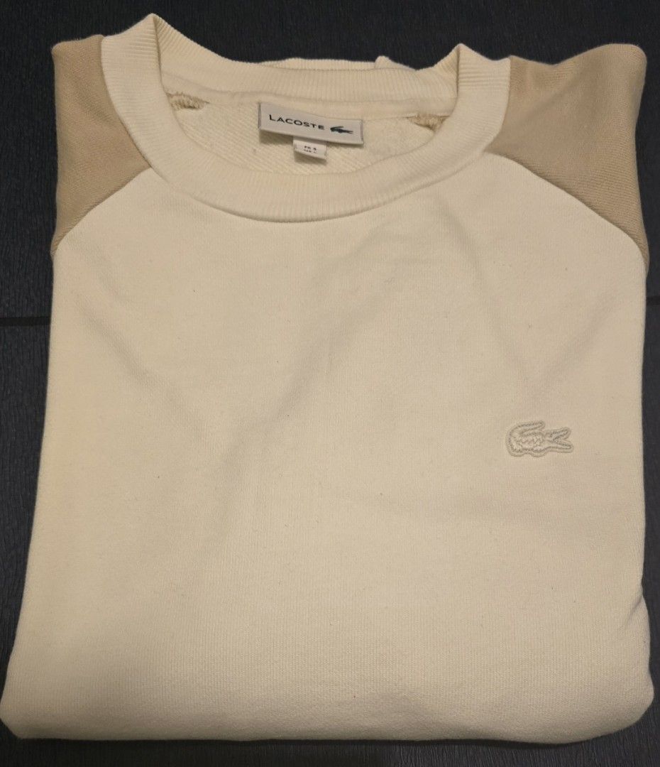 Lacoste (Category: Coats, Jackets and Outerwear) located in Quezon City. Submitted by ShoesManila (Listing ID 1460681054, Image 2). Description: - Brand: Lacoste - Size: XL (EU 54 / UK 44 / US 44) - Color: Cream, Beige - Features: Embroidered Lacoste croc logo, zippered side pocket - Material: Cotton and Acrylic blend -Color rate: 9.5/10 - Condition: Excellent, pre-loved - Style: Casual, comfortable - Loc: Diliman -SF c/o buyer.