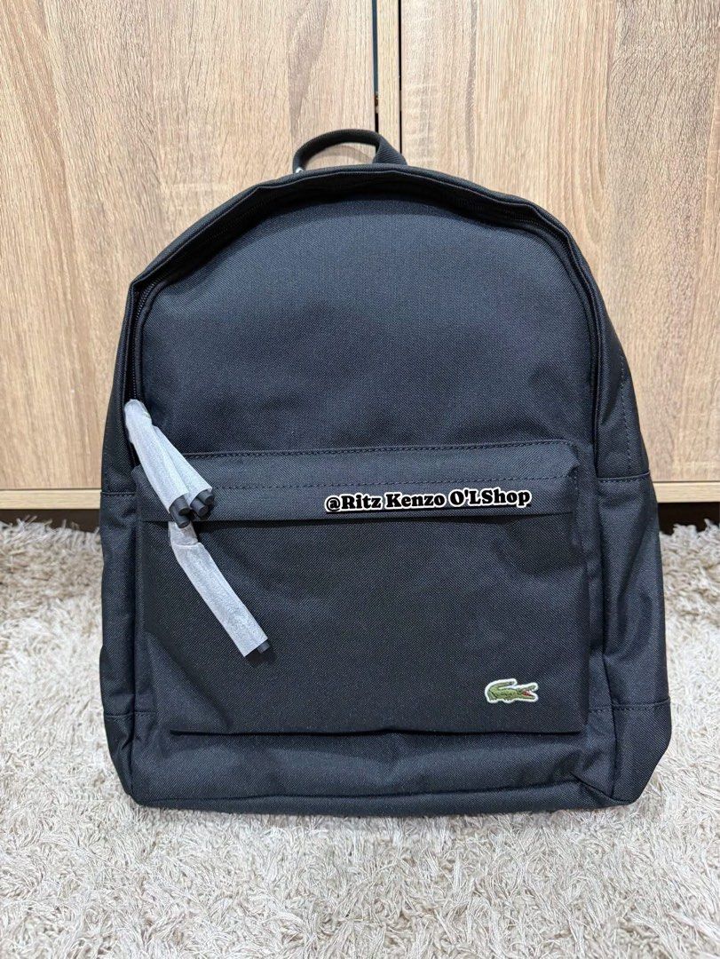 Lacoste Backpack Black Polyester CANS126 (Category: Backpacks) located in Antipolo. Submitted by ritzkenzo_olshop06 (Listing ID 1460538434, Image 1). Description: - Authentic Black Lacoste Backpack - Durable Polyester Material - Zippered Front Pocket for easy access - Spacious Main Compartment with Interior Sleeve - Navy Blue Interior Lining - Brand New with Tags Attached - Ideal for Everyday Use.