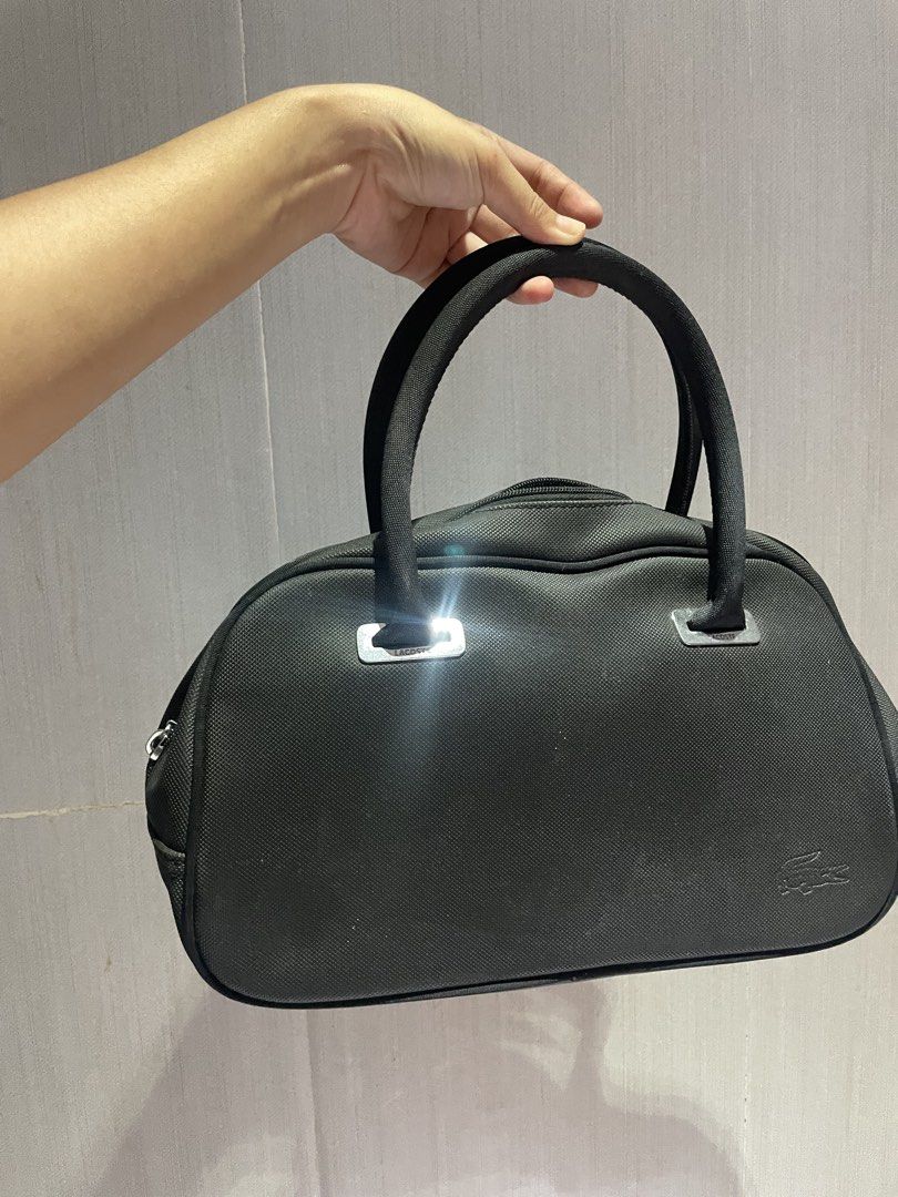 Lacoste Black Bowling Bag (Category: Tote Bags) located in Iligan City. Submitted by lisiantbel (Listing ID 1460659662, Image 1). Description: - Authentic Black Lacoste Boston Bag - Durable Canvas Material - Zippered Main Compartment - Internal Pockets for Organization - Dual Top Handles for Easy Carrying - Iconic Embossed Lacoste Crocodile Logo on Front - Ideal for Everyday Use.