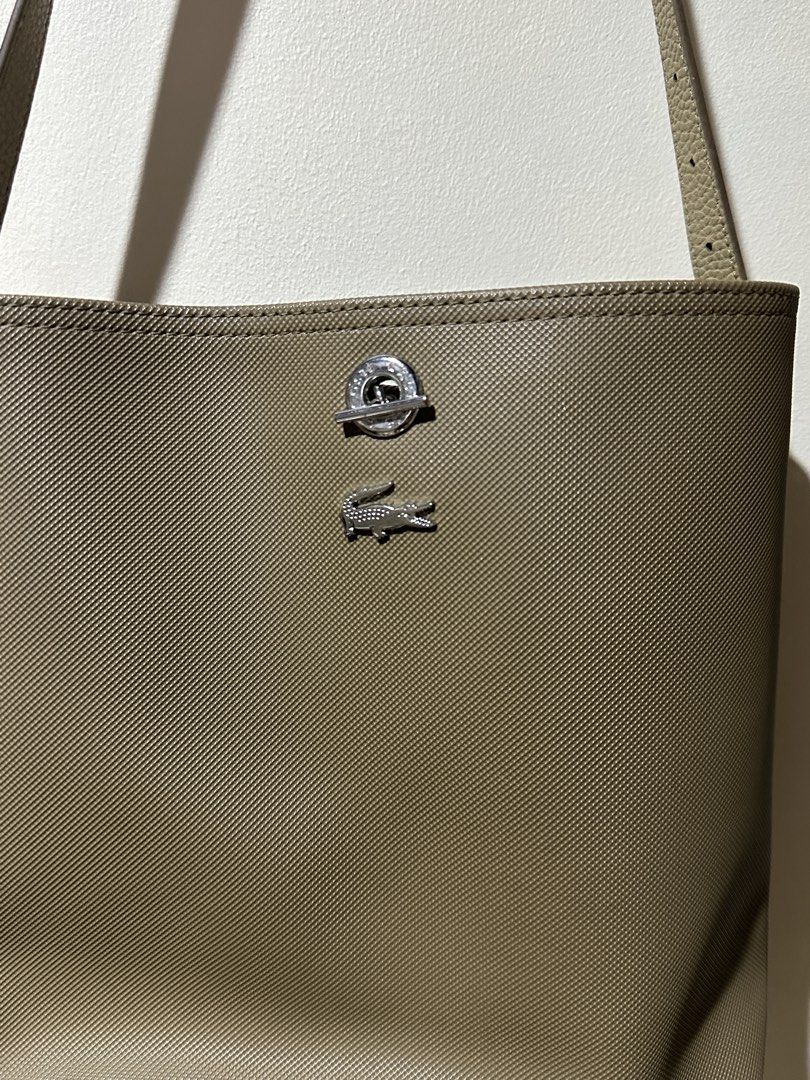 Lacoste Bucket Bag (Category: Shoulder Bags) located in Marikina City. Submitted by abyrivera (Listing ID 1460700335, Image 2). Description: In good condition. Flaw: Hardware marks and a tiny black stain. Inclusion: Dust bag only Bought this from Lacoste in UP Town Center last 2022 .