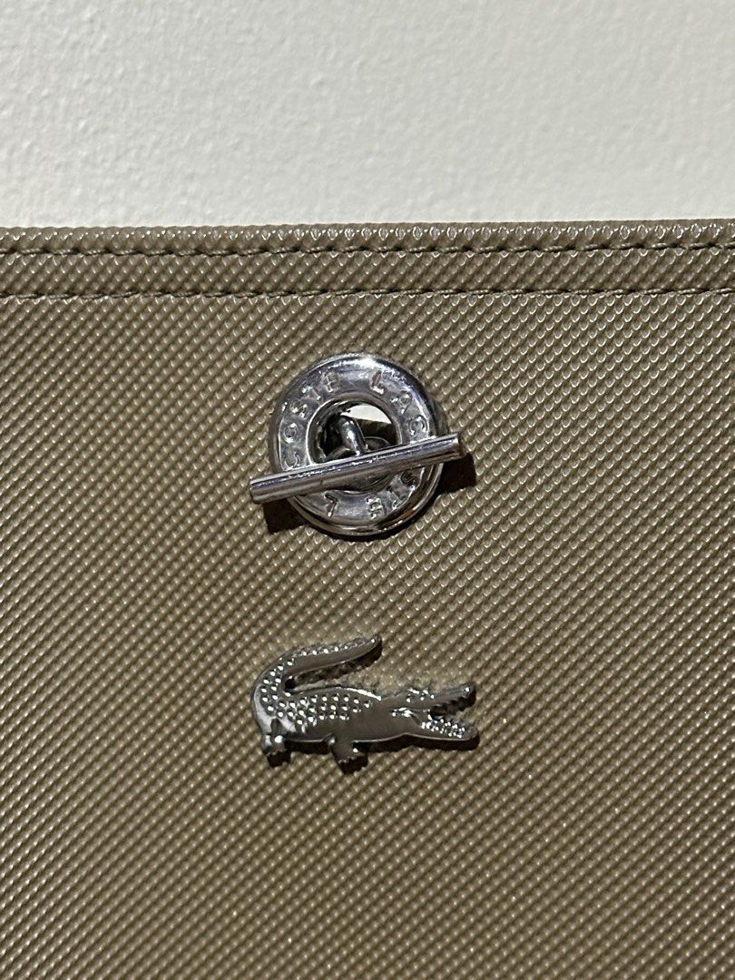 Lacoste Bucket Bag (Category: Shoulder Bags) located in Marikina City. Submitted by abyrivera (Listing ID 1460700335, Image 3). Description: In good condition. Flaw: Hardware marks and a tiny black stain. Inclusion: Dust bag only Bought this from Lacoste in UP Town Center last 2022 .