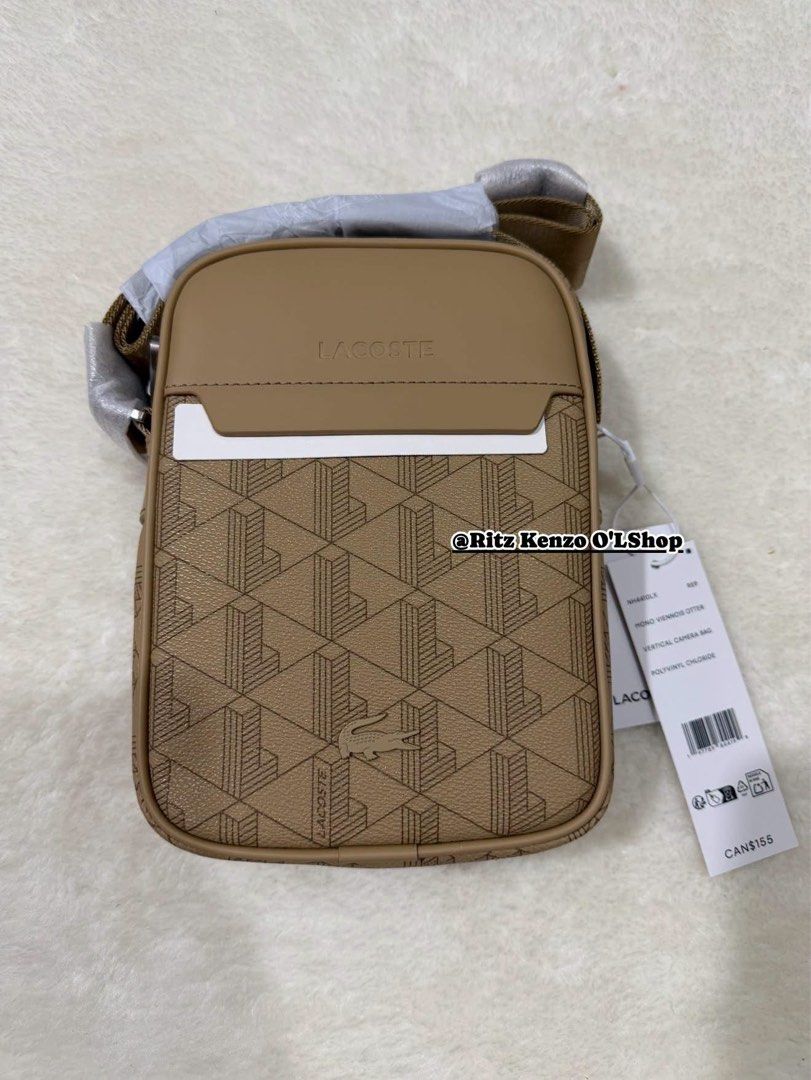 Lacoste Monogram Print Vertical Camera Bag Tan (Category: Cross-body Bags) located in Antipolo. Submitted by ritzkenzo_olshop06 (Listing ID 1460538606, Image 1). Description: - Stylish Lacoste camera bag with all-over tan monogram print. - Iconic signature crocodile logo detail. - Adjustable strap for comfortable wear. - Secure zipper closure. - Vibrant bright orange interior lining. - Ideal for everyday use and carrying essentials..
