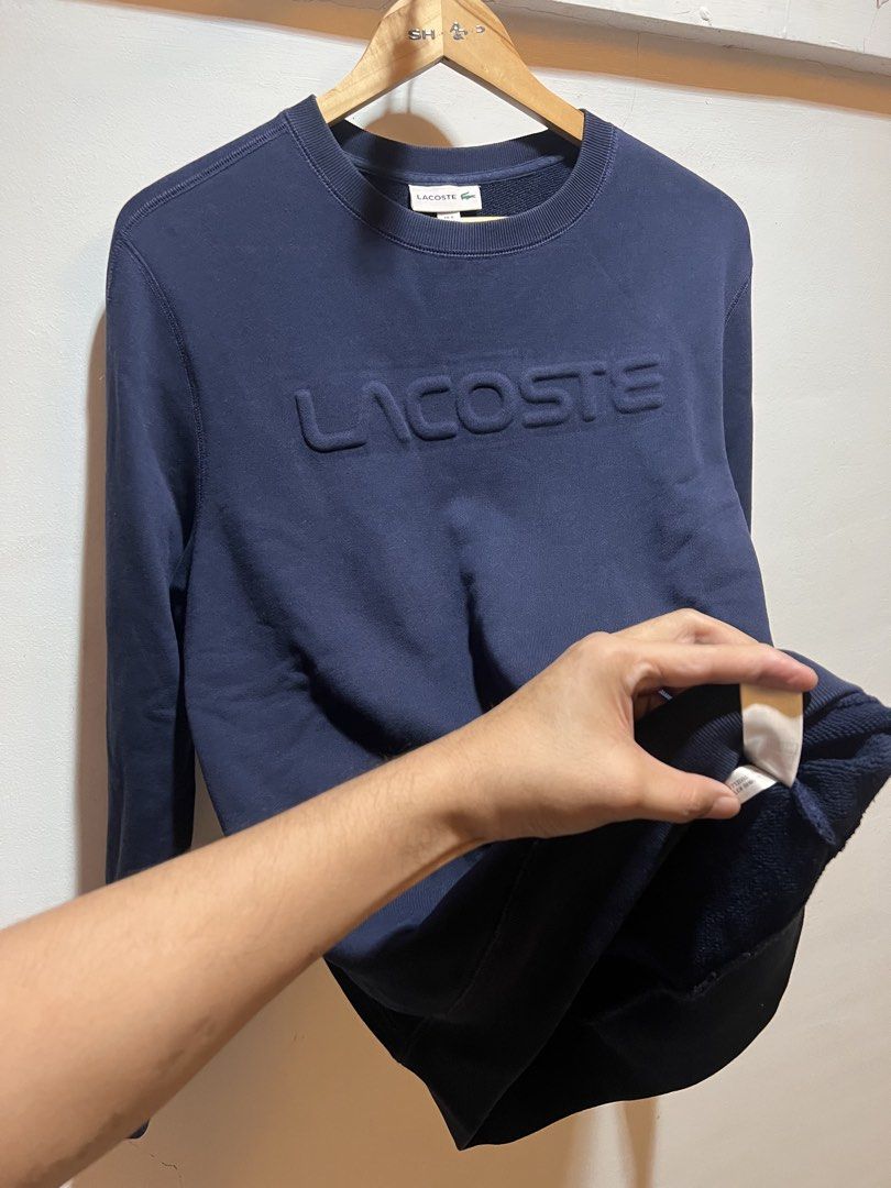 Lacoste Navy Blue Embossed Logo Sweatshirt (Category: Coats, Jackets and Outerwear) located in San Juan, La Union. Submitted by jeggystyle (Listing ID 1460525911, Image 2). Description: - Navy blue Lacoste sweatshirt - Features a raised embossed Lacoste logo on the front - Crew neck, long sleeves - Ribbed cuffs and hem - Ideal for comfortable and stylish casual wear Authentic large fittings.