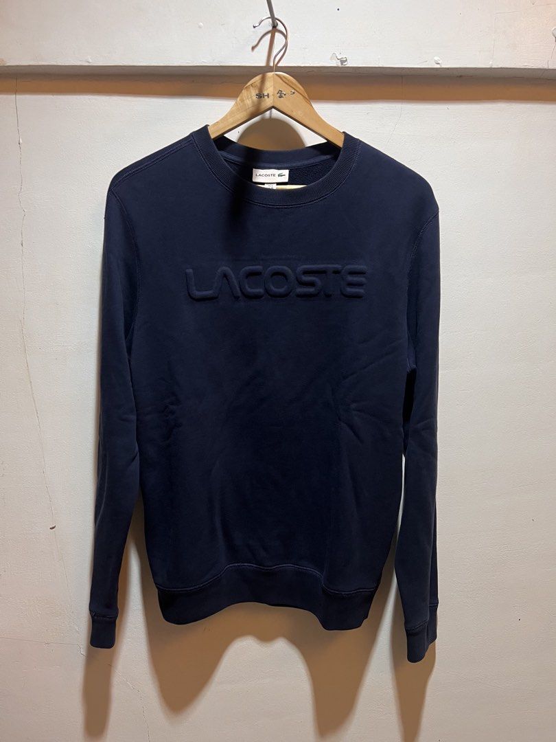 Lacoste Navy Blue Embossed Logo Sweatshirt (Category: Coats, Jackets and Outerwear) located in San Juan, La Union. Submitted by jeggystyle (Listing ID 1460525911, Image 1). Description: - Navy blue Lacoste sweatshirt - Features a raised embossed Lacoste logo on the front - Crew neck, long sleeves - Ribbed cuffs and hem - Ideal for comfortable and stylish casual wear Authentic large fittings.