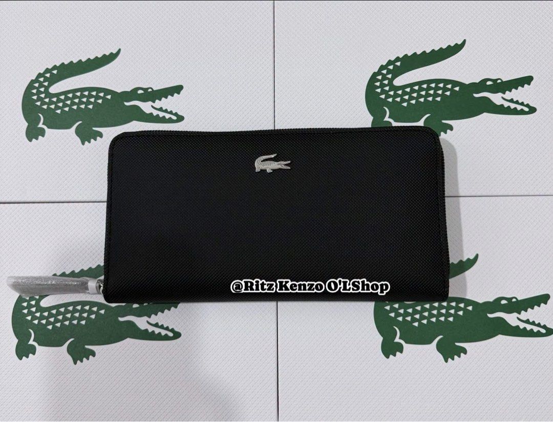 Lacoste Noir L Zip Wallet Polyvinyl Chloride (Category: Wallets & Card Holders) located in Antipolo. Submitted by ritzkenzo_olshop06 (Listing ID 1460538799, Image 1). Description: - Authentic Lacoste wallet in black - Model NF4776OV - Secure zip-around closure - Ample card slots and compartments for organization - Durable polyvinyl chloride (PVC) material - Comes with original tag.