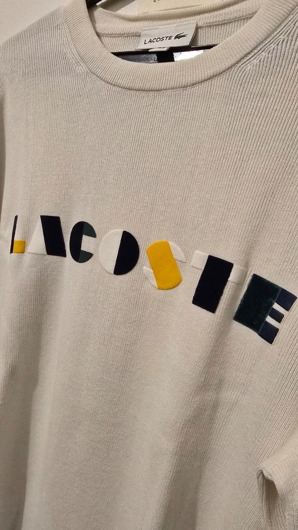 Lacoste White Sweater with Colourful Logo (Category: Coats, Jackets and Outerwear) located in Quezon City. Submitted by ShoesManila (Listing ID 1460681681, Image 3). Description: - Classic white Lacoste sweater -Width 22 Length 27 - Features iconic colorful block logo across the chest - Small embroidered crocodile logo on the left cuff - Ribbed cuffs and hem for a comfortable fit - Ideal for everyday casual wear -Color rate 10/10 -Condition: Exce