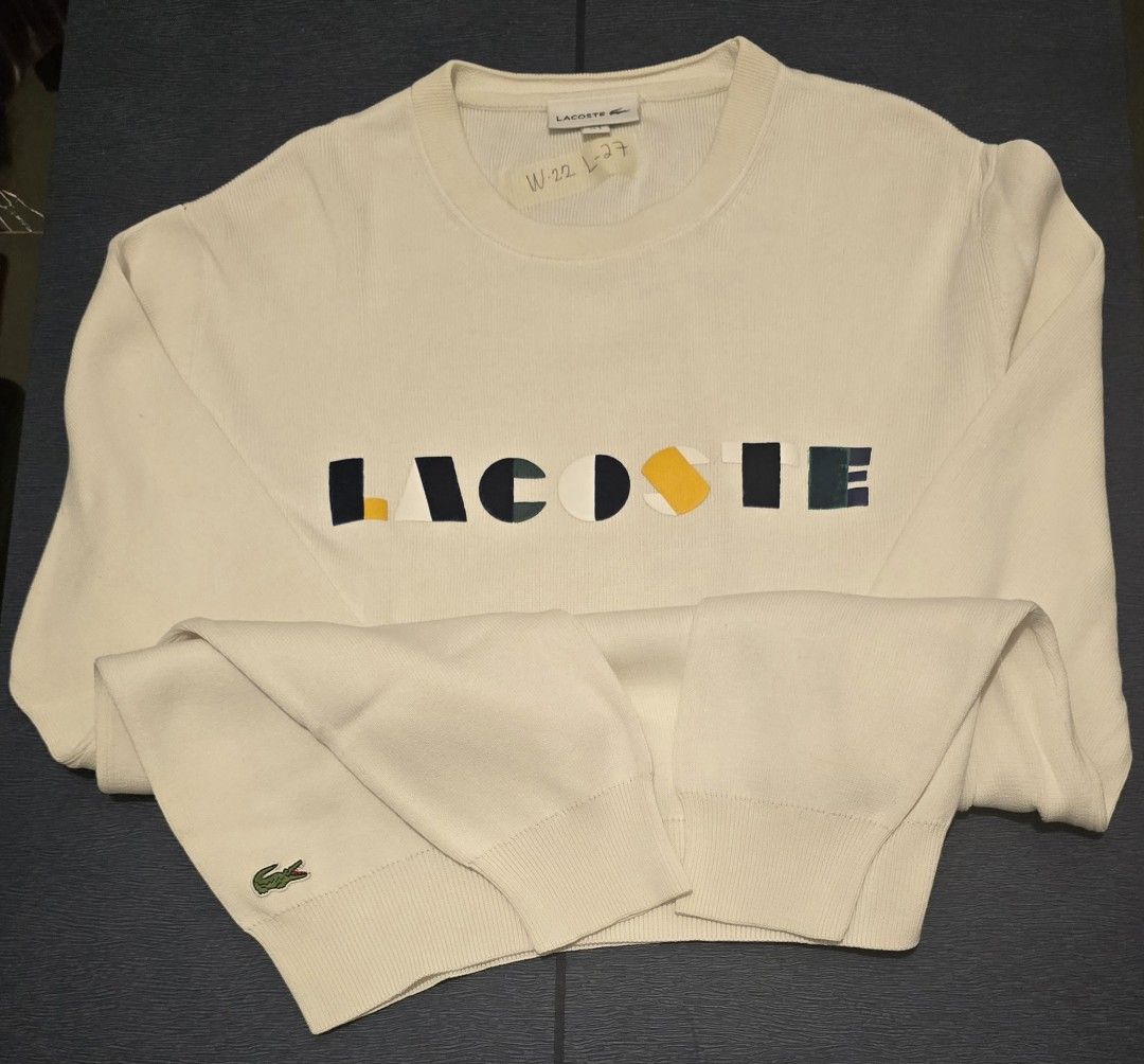 Lacoste White Sweater with Colourful Logo (Category: Coats, Jackets and Outerwear) located in Quezon City. Submitted by ShoesManila (Listing ID 1460681681, Image 1). Description: - Classic white Lacoste sweater -Width 22 Length 27 - Features iconic colorful block logo across the chest - Small embroidered crocodile logo on the left cuff - Ribbed cuffs and hem for a comfortable fit - Ideal for everyday casual wear -Color rate 10/10 -Condition: Exce