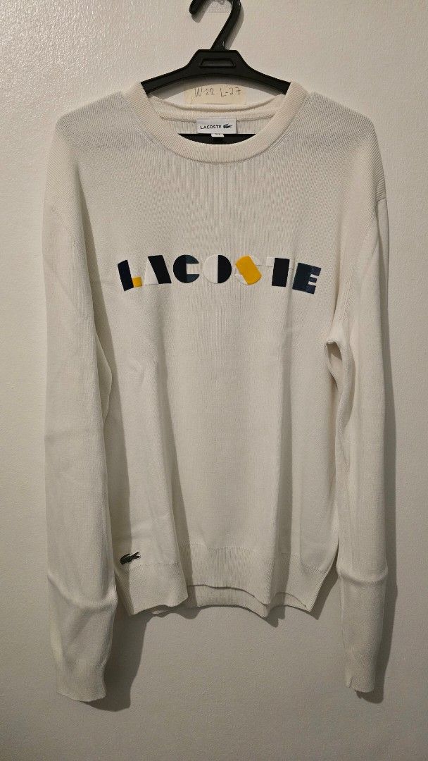 Lacoste White Sweater with Colourful Logo (Category: Coats, Jackets and Outerwear) located in Quezon City. Submitted by ShoesManila (Listing ID 1460681681, Image 2). Description: - Classic white Lacoste sweater -Width 22 Length 27 - Features iconic colorful block logo across the chest - Small embroidered crocodile logo on the left cuff - Ribbed cuffs and hem for a comfortable fit - Ideal for everyday casual wear -Color rate 10/10 -Condition: Exce