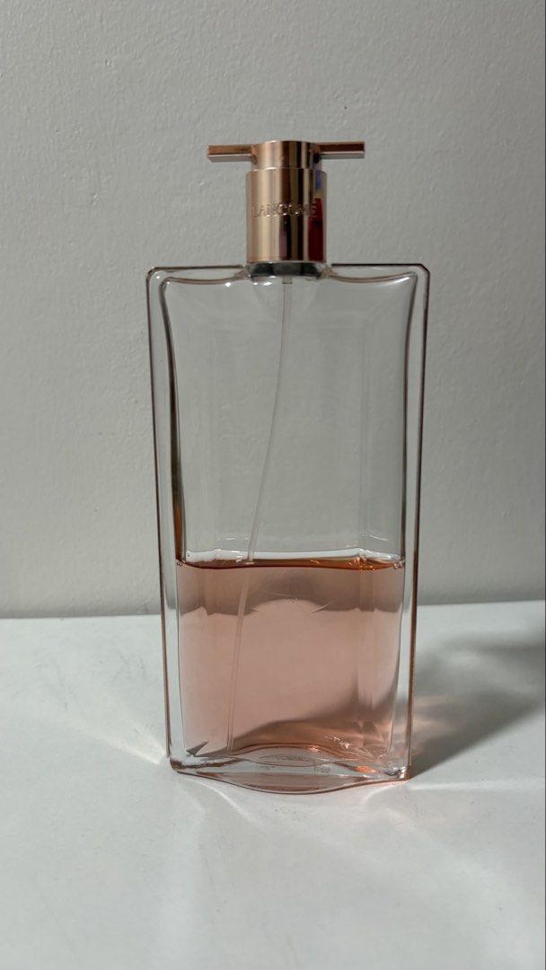 Lancome Idôle Eau De Parfum (Category: Fragrance & Deodorants) located in Iba. Submitted by fruitypebblezz (Listing ID 1460679223, Image 1). Description: - Lancome perfume bottle - Clear glass with rose gold pump - Light pink perfume, approximately half full - Perfect for lovers of floral scents.