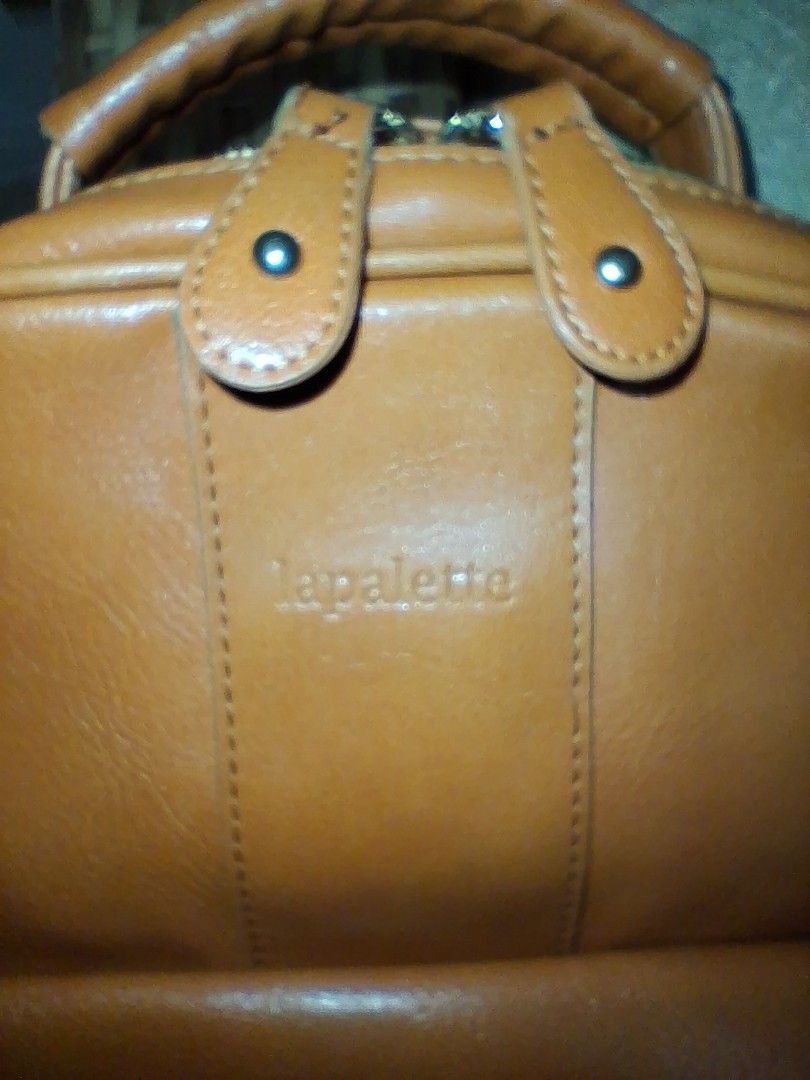 LaPalette Brown Leather Backpack with Deer Logo (Category: Backpacks) located in Angeles City. Submitted by anneps (Listing ID 1460639642, Image 2). Description: - Brown leather backpack from LaPalette - Features a cute deer logo on the front pocket - Adjustable straps and a top handle for comfortable carrying - Spacious interior lined with tan fabric - Smoothly working zippers - Ideal for everyday use.