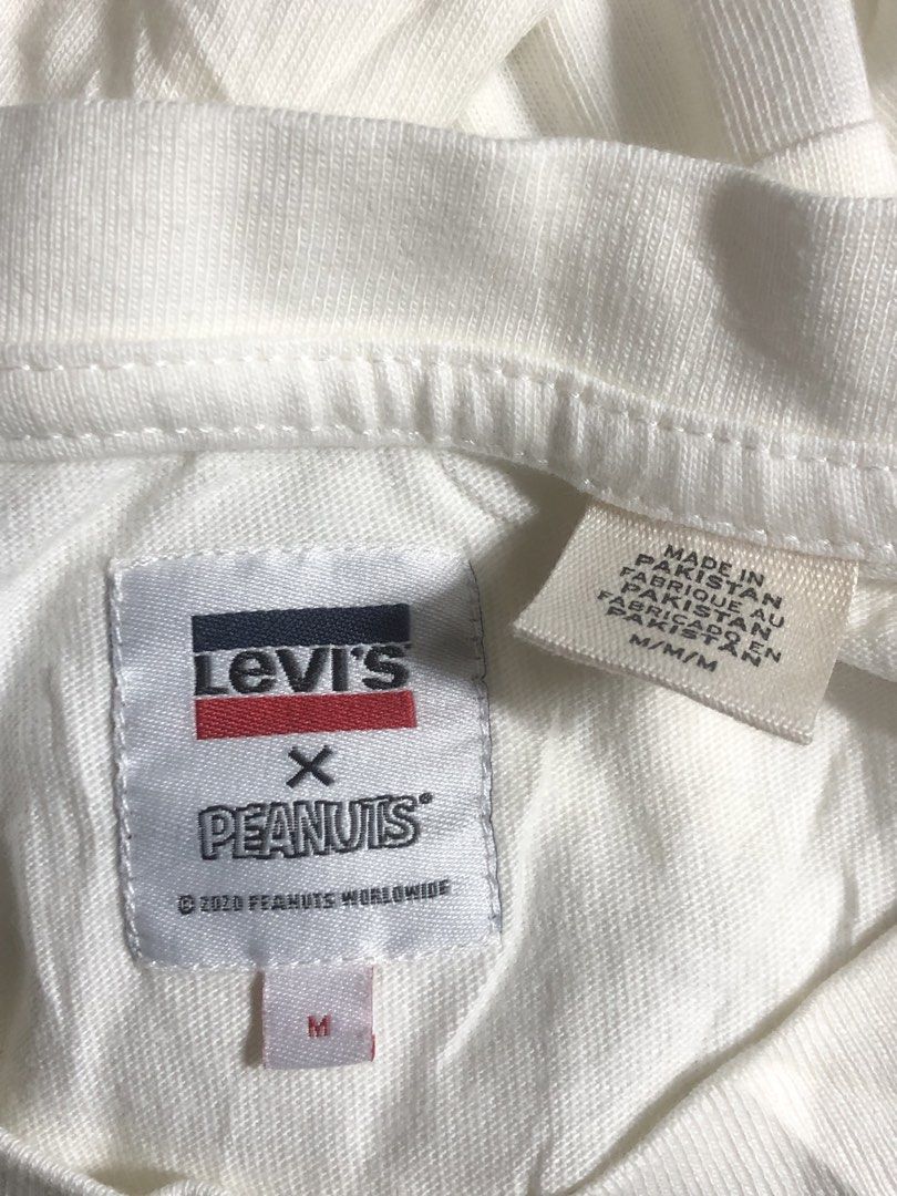 Levi's x Peanuts Snoopy Soccer Graphic Tee (Category: Tshirts & Polo Shirts ) located in Montevista. Submitted by rdthriftshub (Listing ID 1460660604, Image 2). Description: - White Levi's x Peanuts collaboration t-shirt - Features Snoopy graphic with 'Goal! Goal! Goal!' text and soccer ball - Blue and yellow striped sleeve accents - 100% cotton material - Tagged size M, fits like an XL -Dimension:23x28 Excellent condition .