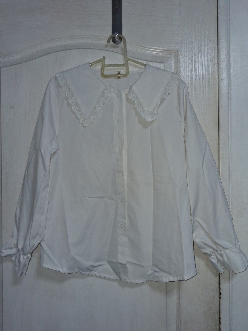 Lolita Top (Category: Blouses) located in Baguio. Submitted by arowarwai (Listing ID 1460666928, Image 1). Description: - Style: Lolita Top - Color: White - Size: Medium (EU 38 / UK 10 / US 6) - Features: Delicate lace trim on collar and cuffs - Condition: Excellent, pre-loved - Perfect for a sweet and feminine look.