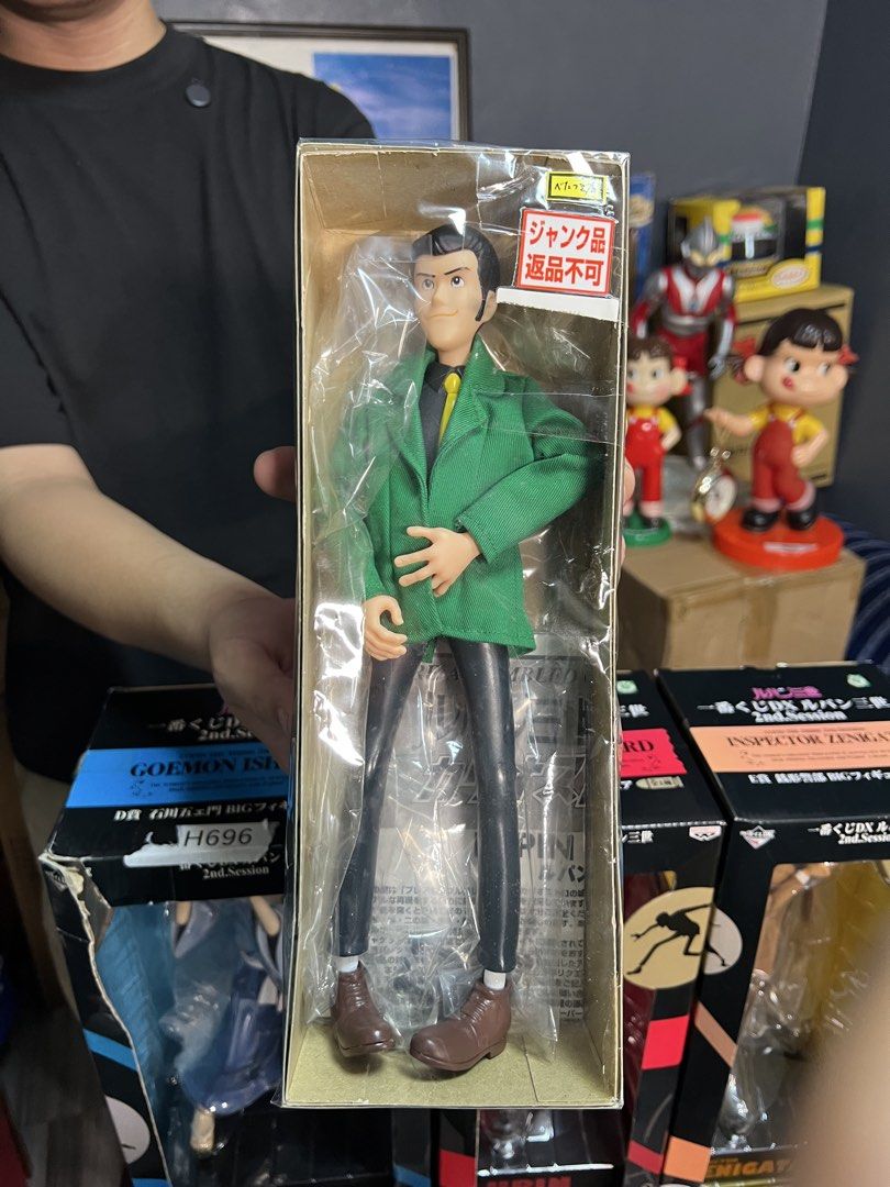Lupin the Third Figure - Green Jacket (Category: Figurines & Statues) located in Manila. Submitted by thegreyhousemarket (Listing ID 1460700565, Image 1). Description: - Brand New: Lupin the Third figure, still sealed in its original box. - Collector's Item: Features other characters like Goemon Ishikawa and Inspector Zenigata on background packaging. - Condition Note: Box has Japanese text including 'Junk Item' and 'No Returns'. There is also so