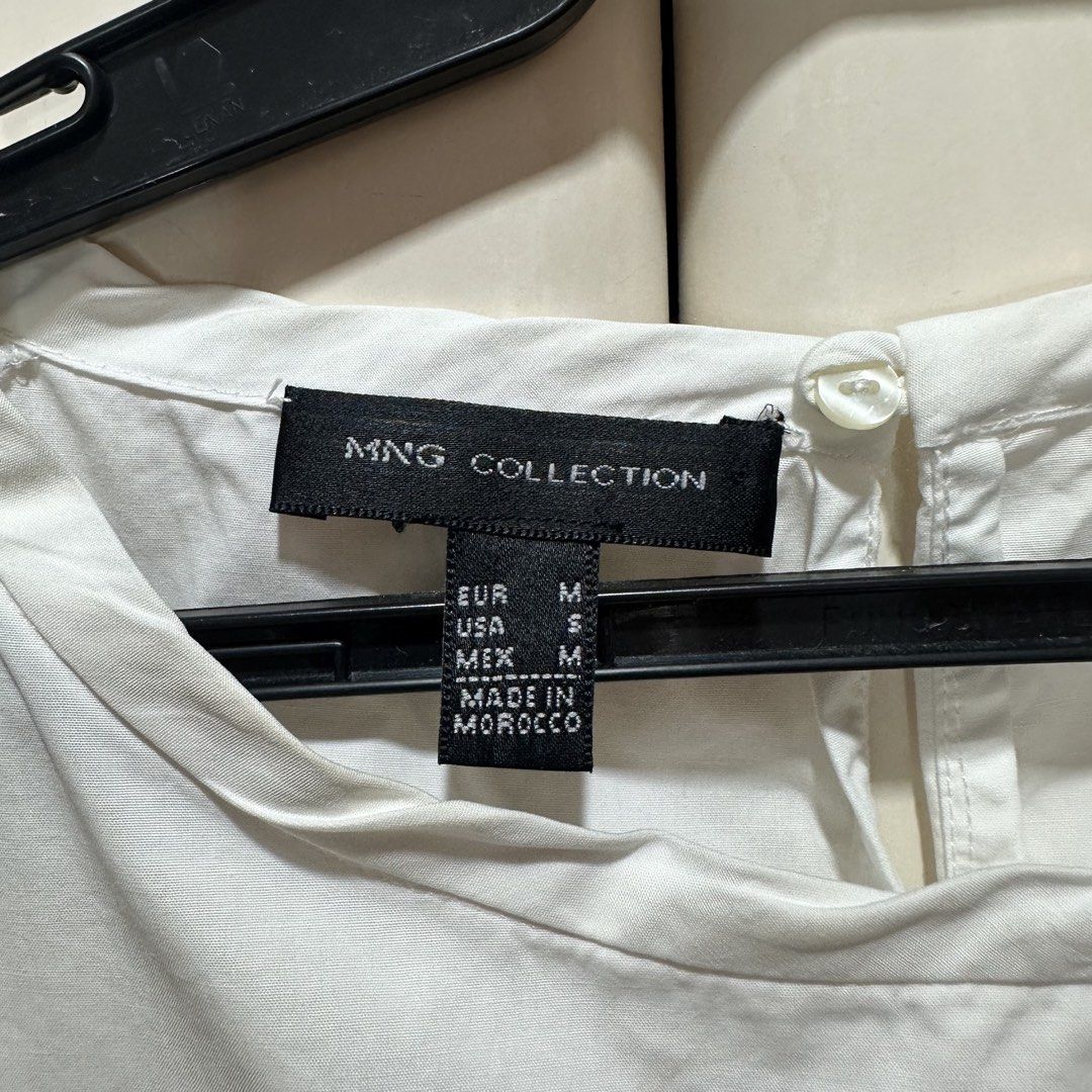 Mango - White Sleeveless Cropped Blouse (Category: Sleeveless) located in Muntinlupa City. Submitted by pickjes (Listing ID 1460700395, Image 3). Description: Brand: Mango (MNG Collection) Size: Medium Color: White Measurements: • Width - 18” • Length - 17.5” Condition: Used only once. No flaws. RFS: Decluttering Details: sleeveless, cropped white blouse from the Mango Collection featuring unique, semi-sheer mesh shoulder panels and a boat neckli
