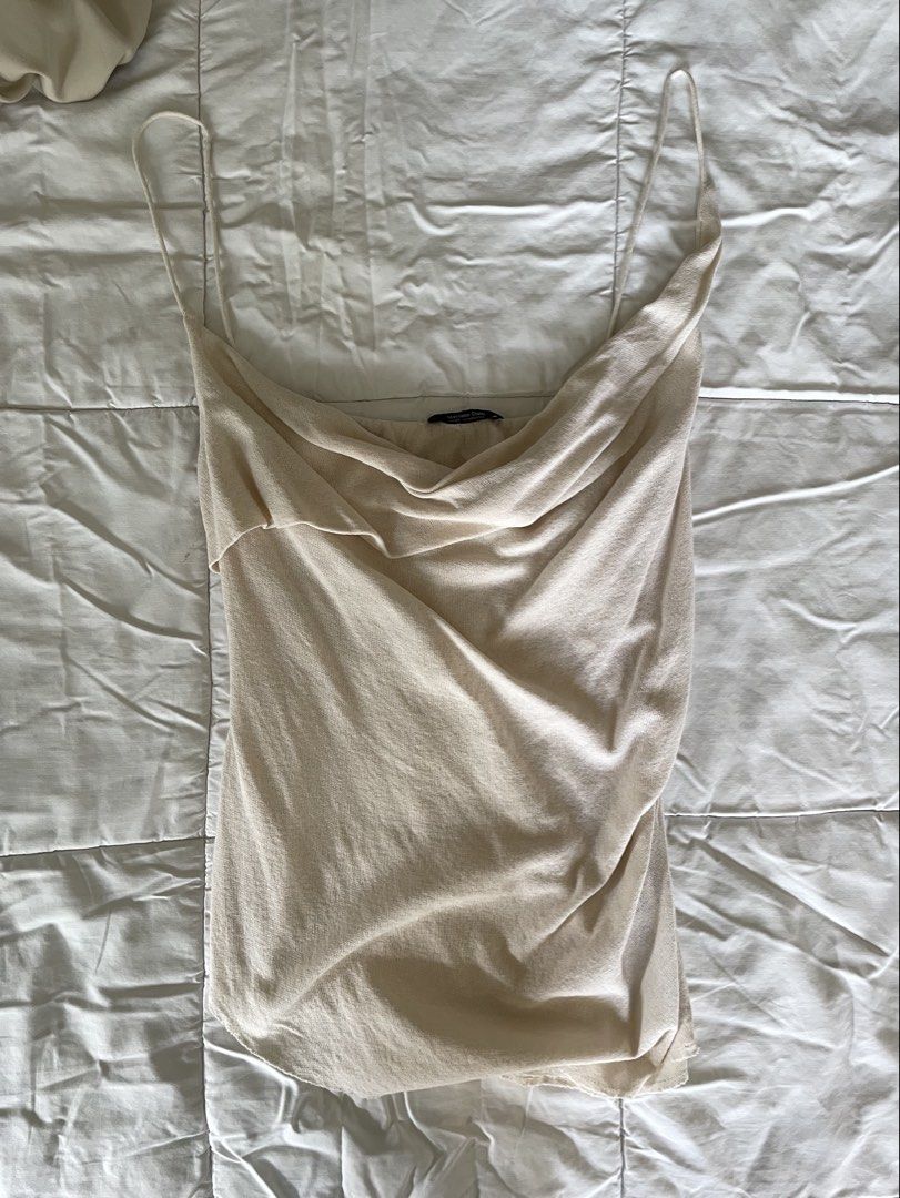 Massimo Dutti Cream Cowl Neck Spaghetti Strap Top (Category: Sleeveless) located in Makati City. Submitted by alyslittlelamb (Listing ID 1460670621, Image 2). Description: - Elegant cream cowl neck top - Delicate spaghetti straps - Lightweight and flowy material - Beautifully drapes for a flattering fit - Versatile: dress up or down - Pairs perfectly with jeans or skirts.
