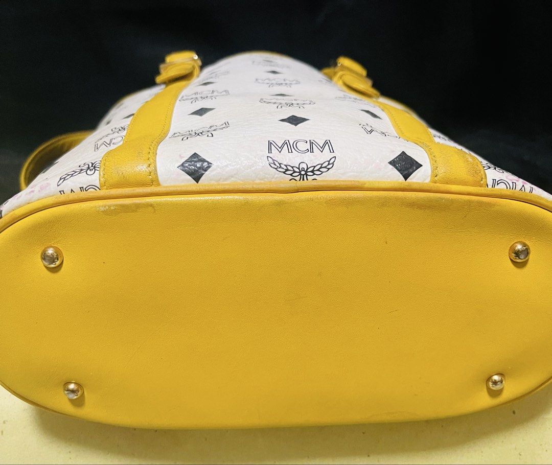 MCM Tote Bag White Yellow Monogram (Category: Luxury Bags & Wallets) located in Manila. Submitted by ermenchita71969 (Listing ID 1460664401, Image 3). Description: - Authentic MCM tote bag in white - Classic MCM monogram pattern all over - Stylish yellow leather trim and handles - Elegant gold-tone hardware with MCM logo plate - Spacious main compartment for all your essentials - Interior zippered pocket for secure storage - Ideal for everyday us