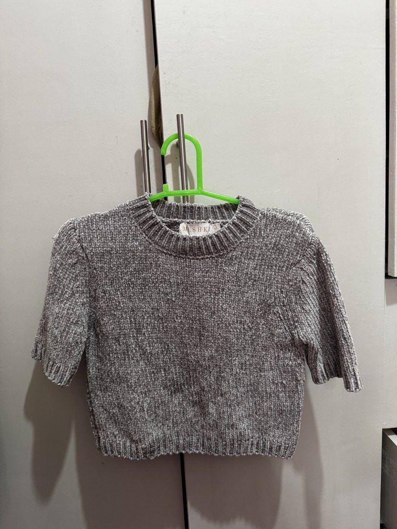 Meshki Grey Chenille Cropped Sweater Size S (Category: Longsleeves) located in Rosales. Submitted by thriftingismygame (Listing ID 1460536231, Image 1). Description: - Grey chenille cropped sweater - Brand: Meshka - Short sleeves - Ribbed hem and neckline - Material: Super soft chenille - Size: S - Care Instructions: Hand wash cold with mild detergent. Do not bleach, soak, wring, tumble dry, iron, or dry clean. Dry flat in shape..