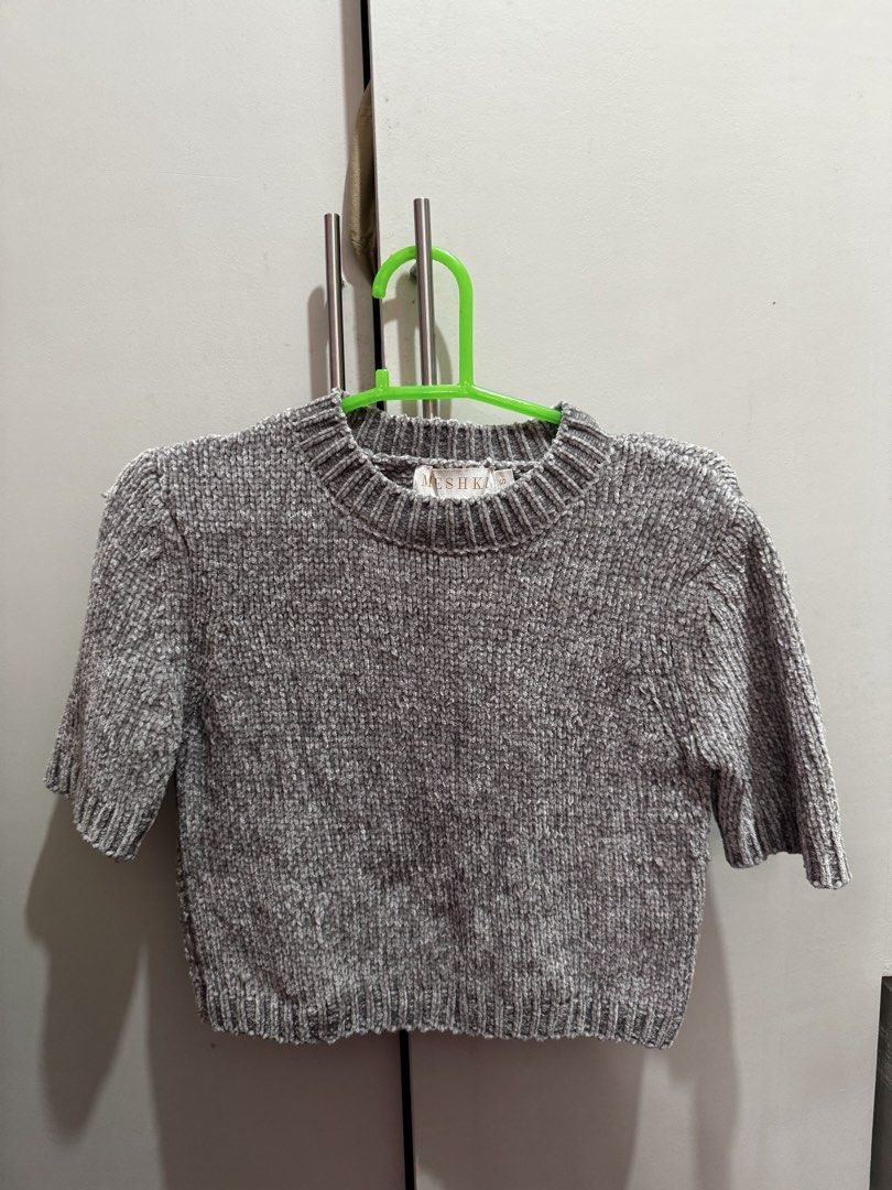 Meshki Grey Chenille Cropped Sweater Size S (Category: Longsleeves) located in Rosales. Submitted by thriftingismygame (Listing ID 1460536231, Image 2). Description: - Grey chenille cropped sweater - Brand: Meshka - Short sleeves - Ribbed hem and neckline - Material: Super soft chenille - Size: S - Care Instructions: Hand wash cold with mild detergent. Do not bleach, soak, wring, tumble dry, iron, or dry clean. Dry flat in shape..