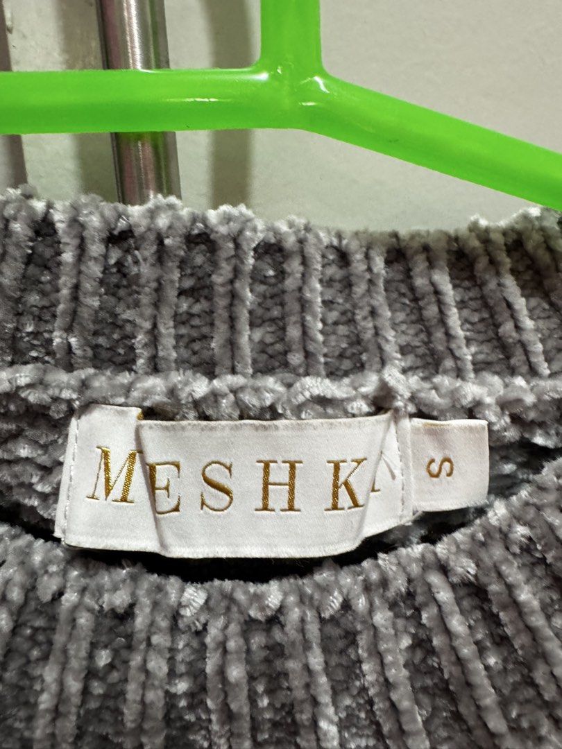 Meshki Grey Chenille Cropped Sweater Size S (Category: Longsleeves) located in Rosales. Submitted by thriftingismygame (Listing ID 1460536231, Image 3). Description: - Grey chenille cropped sweater - Brand: Meshka - Short sleeves - Ribbed hem and neckline - Material: Super soft chenille - Size: S - Care Instructions: Hand wash cold with mild detergent. Do not bleach, soak, wring, tumble dry, iron, or dry clean. Dry flat in shape..