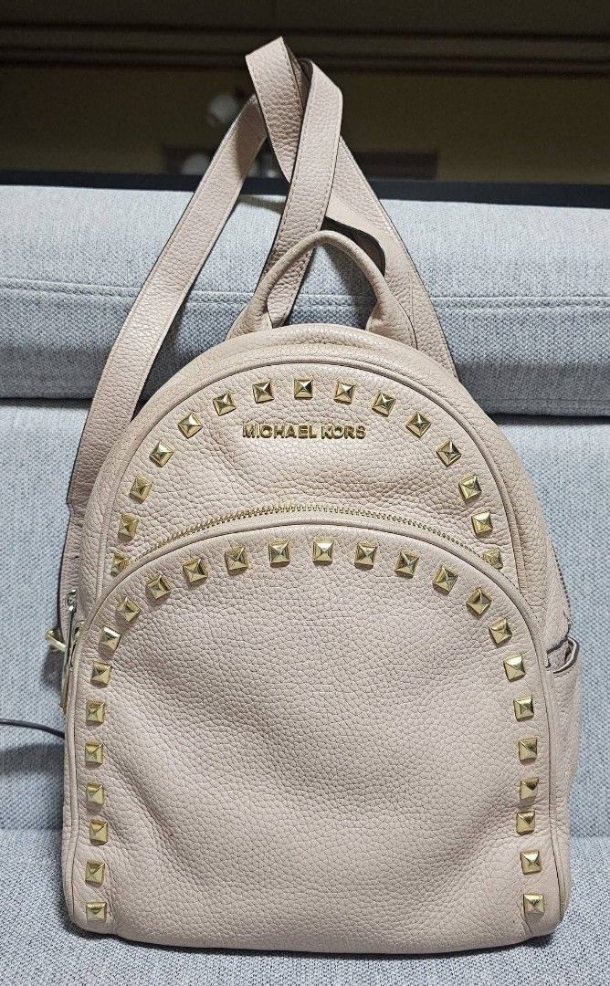 Michael Kors Abbey light pink backpack (Category: Backpacks) located in Tuguegarao City. Submitted by bili_naph (Listing ID 1460525332, Image 2). Description: ☆ Michael Kors Abbey light pink ☆ Studded pebbled leather backpack ☆ Featuring distinctive gold-tone pyramid hardware along the front and trim ☆ Medium size ☆ With adjustable straps ☆ Normal sign of use ☆ No major flaw ☆ BN retails for P18k to P26k ☆ Steal at P1,650.00.